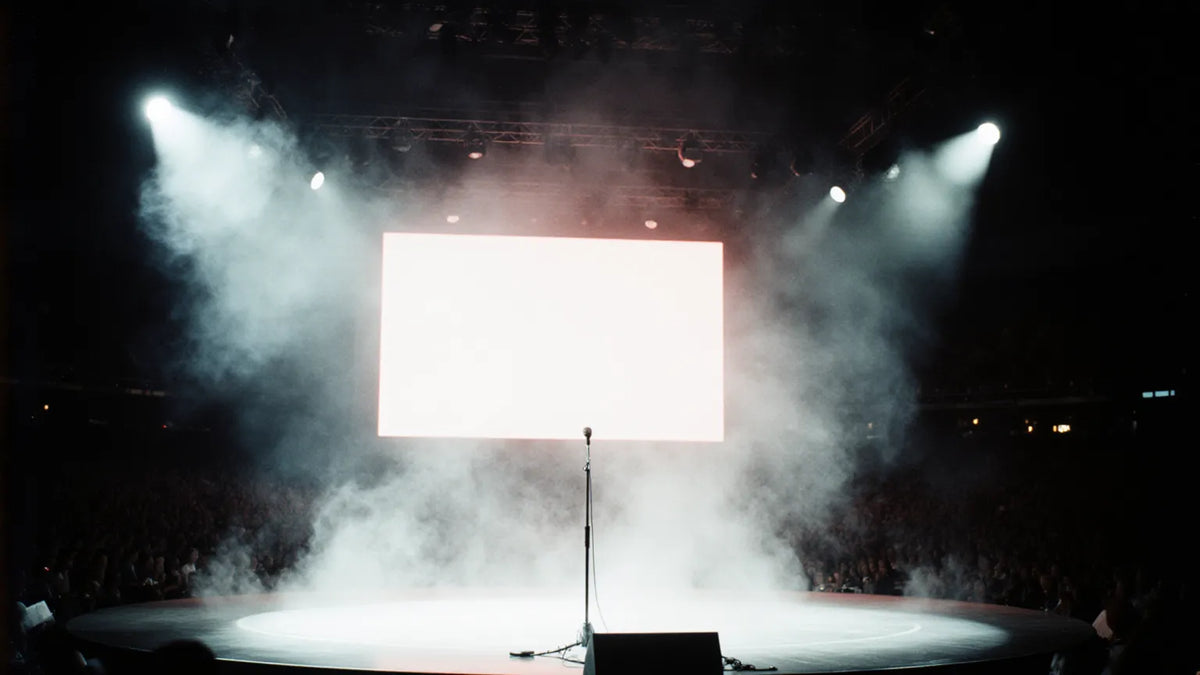 A vintage 1990s Hong Kong Cantopop stadium concert stage at night with an empty microphone stand under floodlights — the arena Sammi Cheng conquered