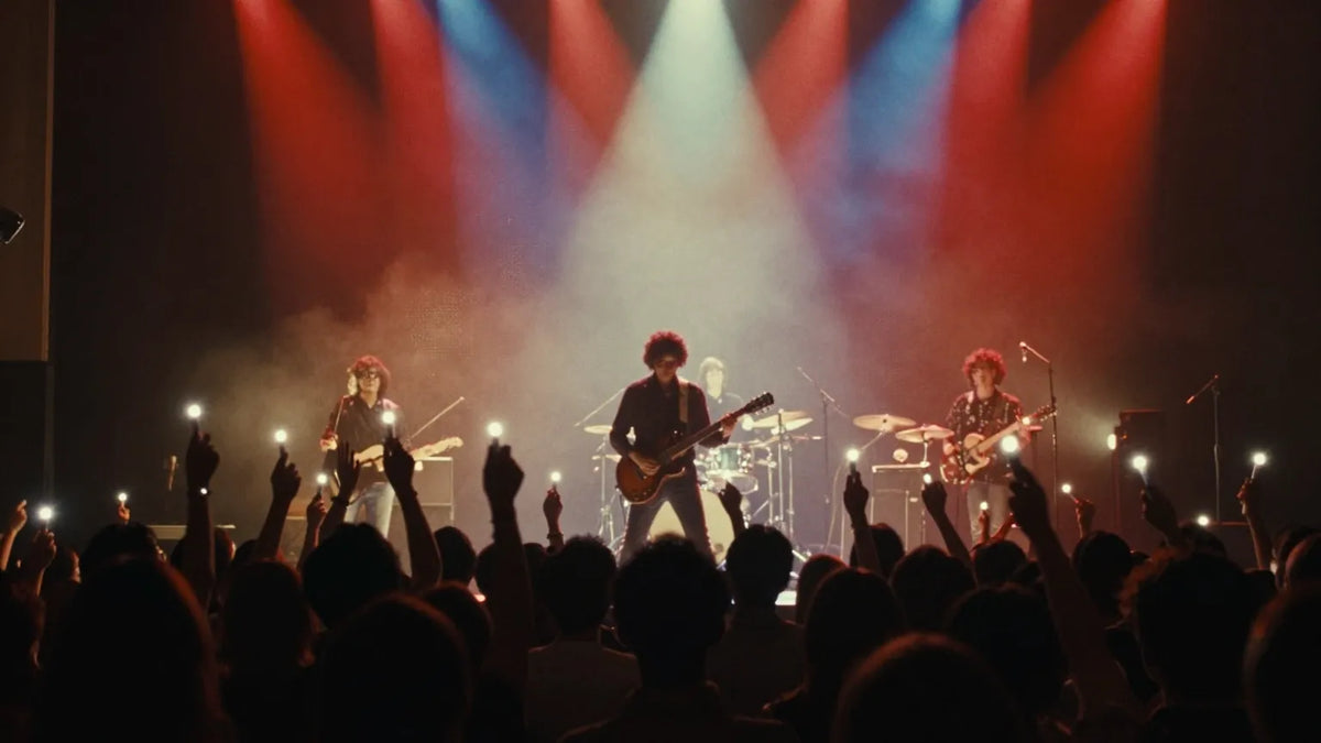 Silhouette of 1980s Hong Kong rock band on stage with crowd raising lighters in red and blue lighting