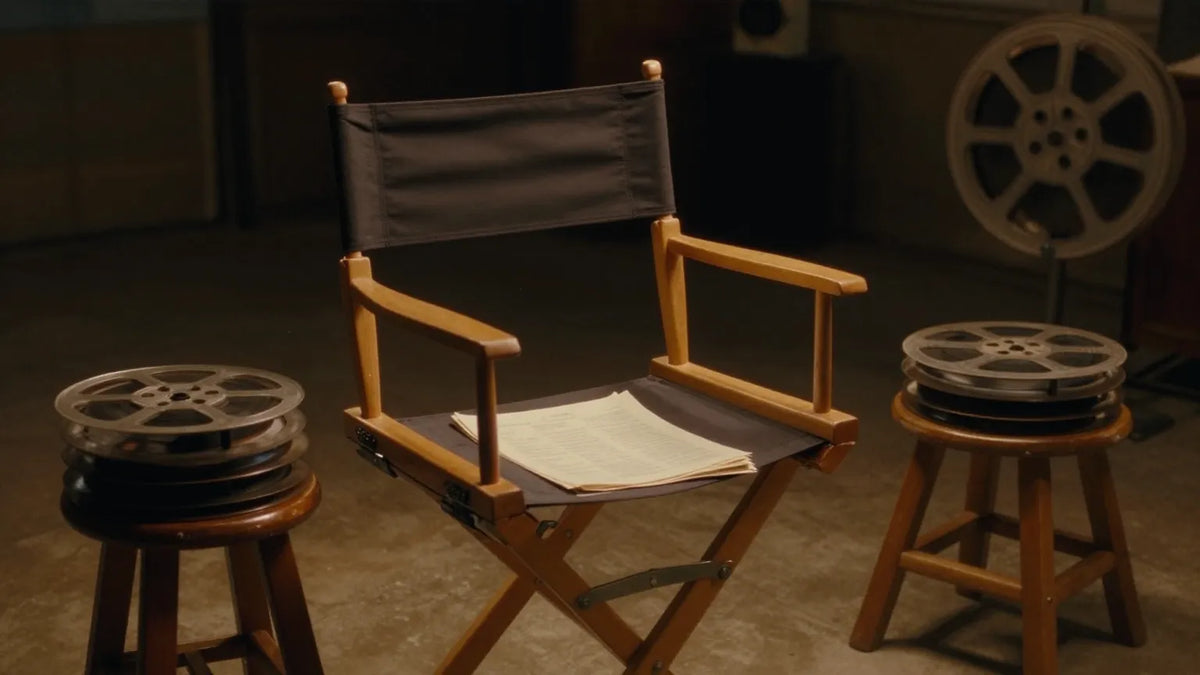 Empty vintage director's chair with a folded script and film reels on a 1980s Hong Kong film set