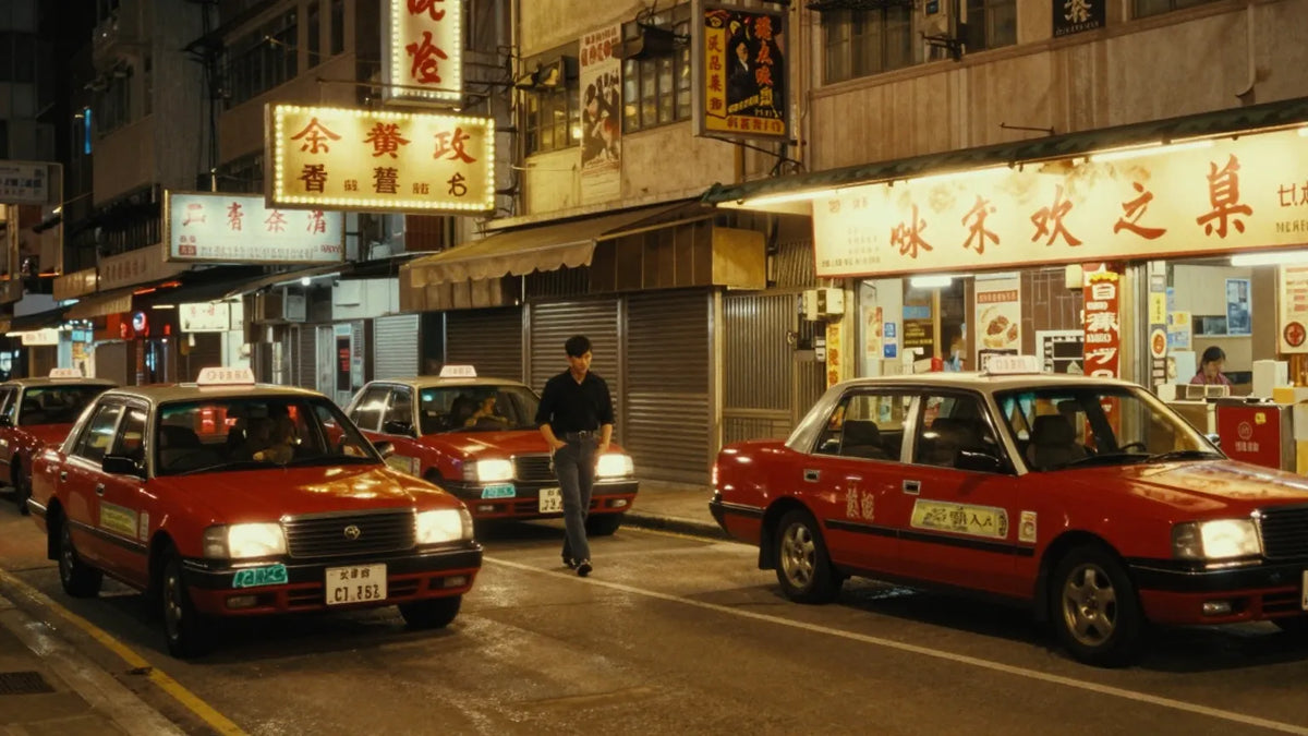 Vintage 1980s Hong Kong cinema street at night with marquee, red taxis and a lone figure