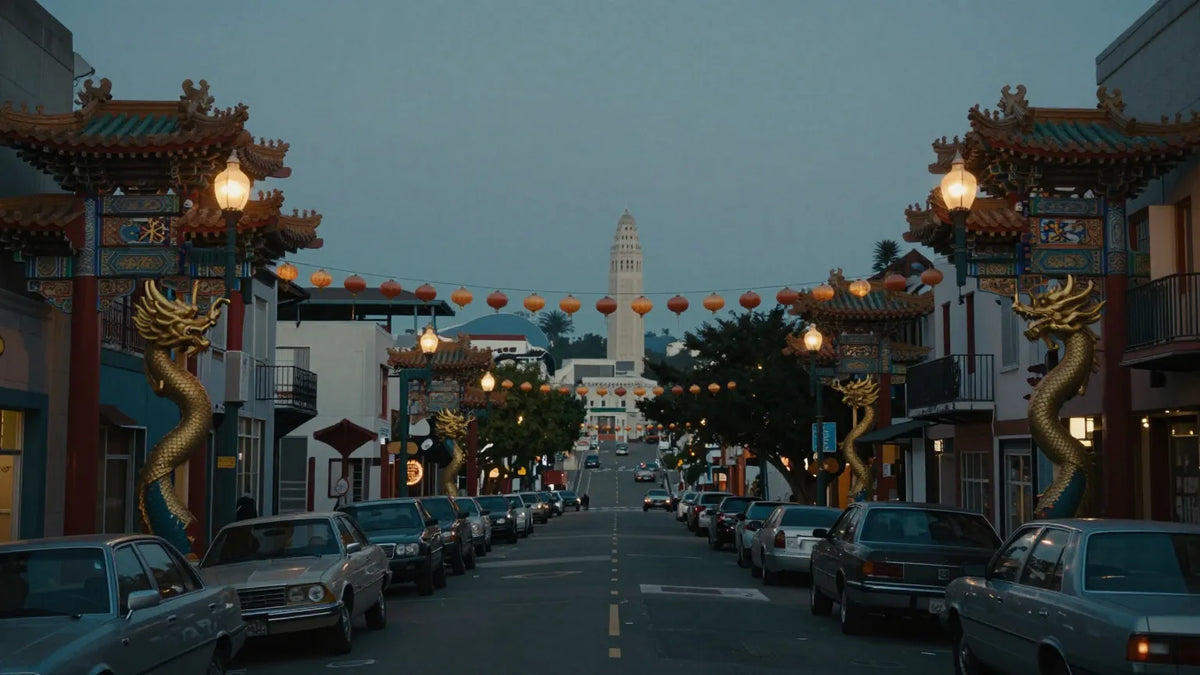 San Francisco Chinatown Grant Avenue at dusk with ornate dragon-wrapped lampposts, red lanterns strung across the street, pagoda-style rooflines and vintage cars