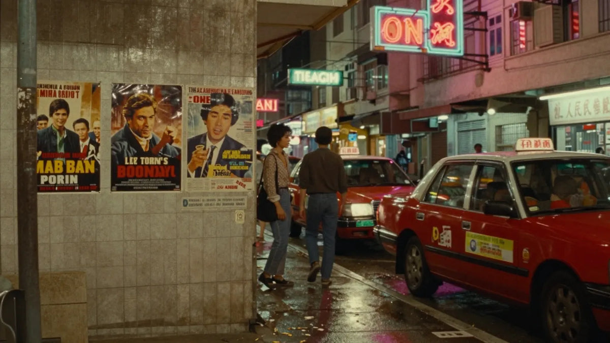 Vintage 1980s Hong Kong cinema street at night with neon signs and red taxis