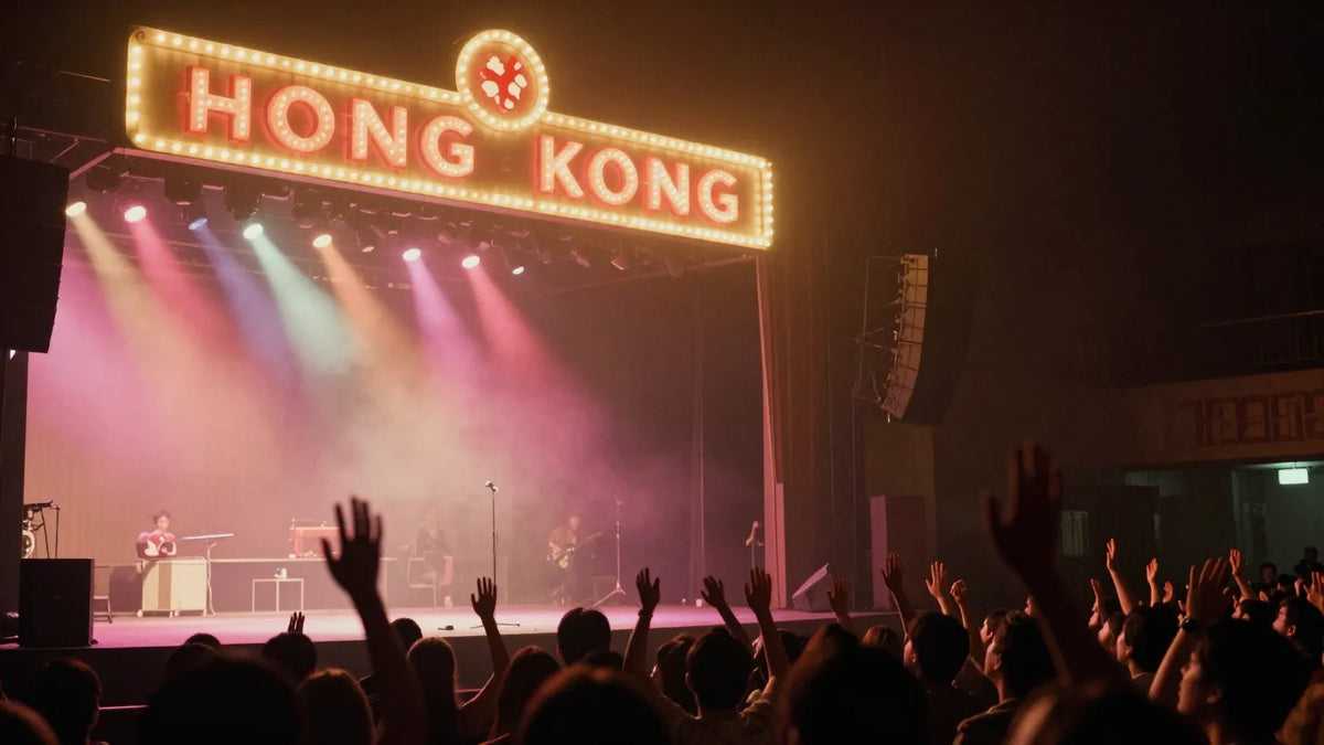 Vintage 1990s Hong Kong concert stage at night with spotlights and audience raising hands