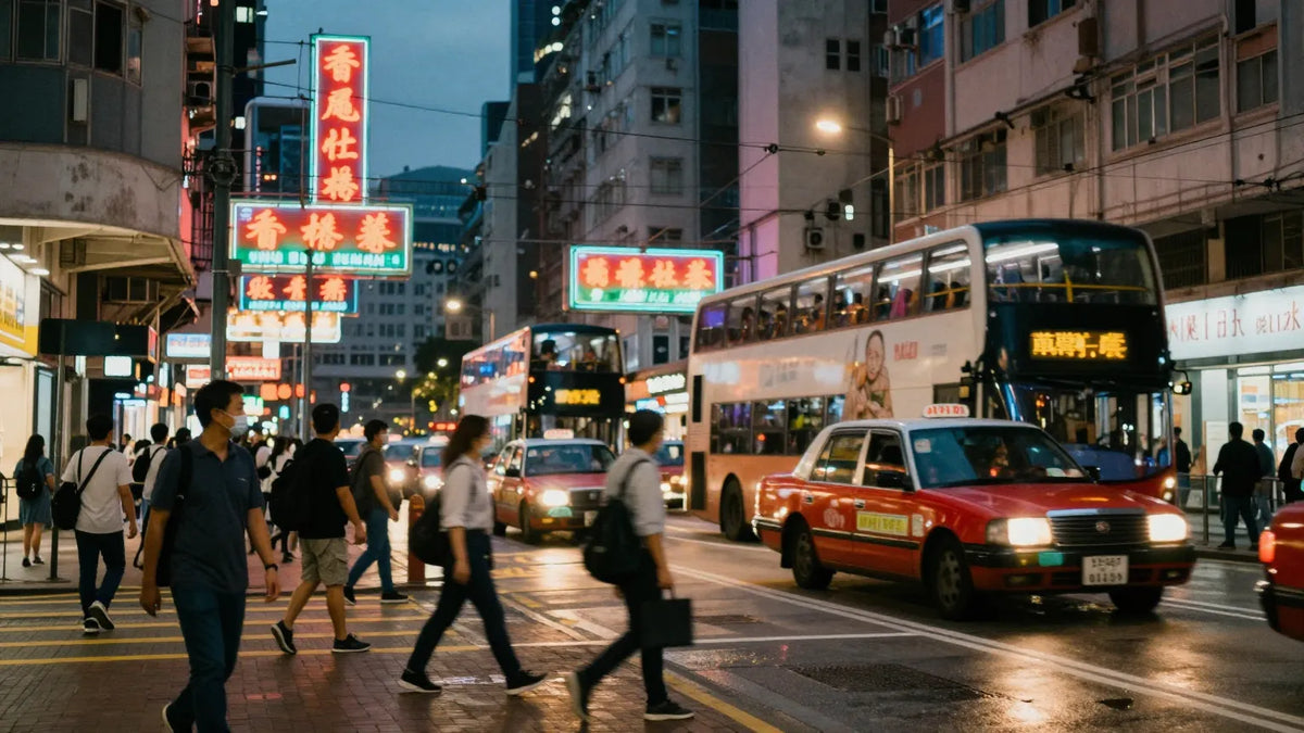Mong Kok Hong Kong intersection at twilight with red taxis double-decker buses and neon signs