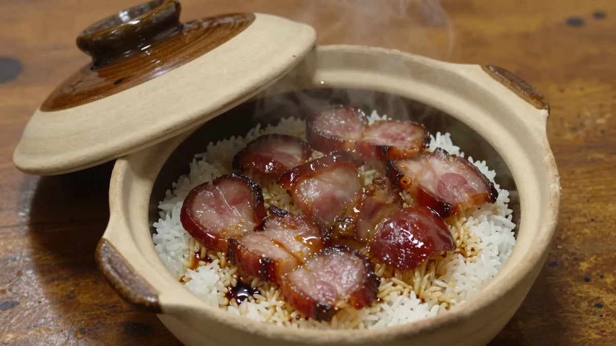 Cantonese clay pot rice close-up with preserved pork belly, Chinese sausage, and dark soy sauce on glistening rice