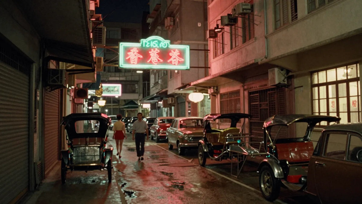 Vintage 1960s Hong Kong Kowloon alley at night with wet pavement and parked rickshaws
