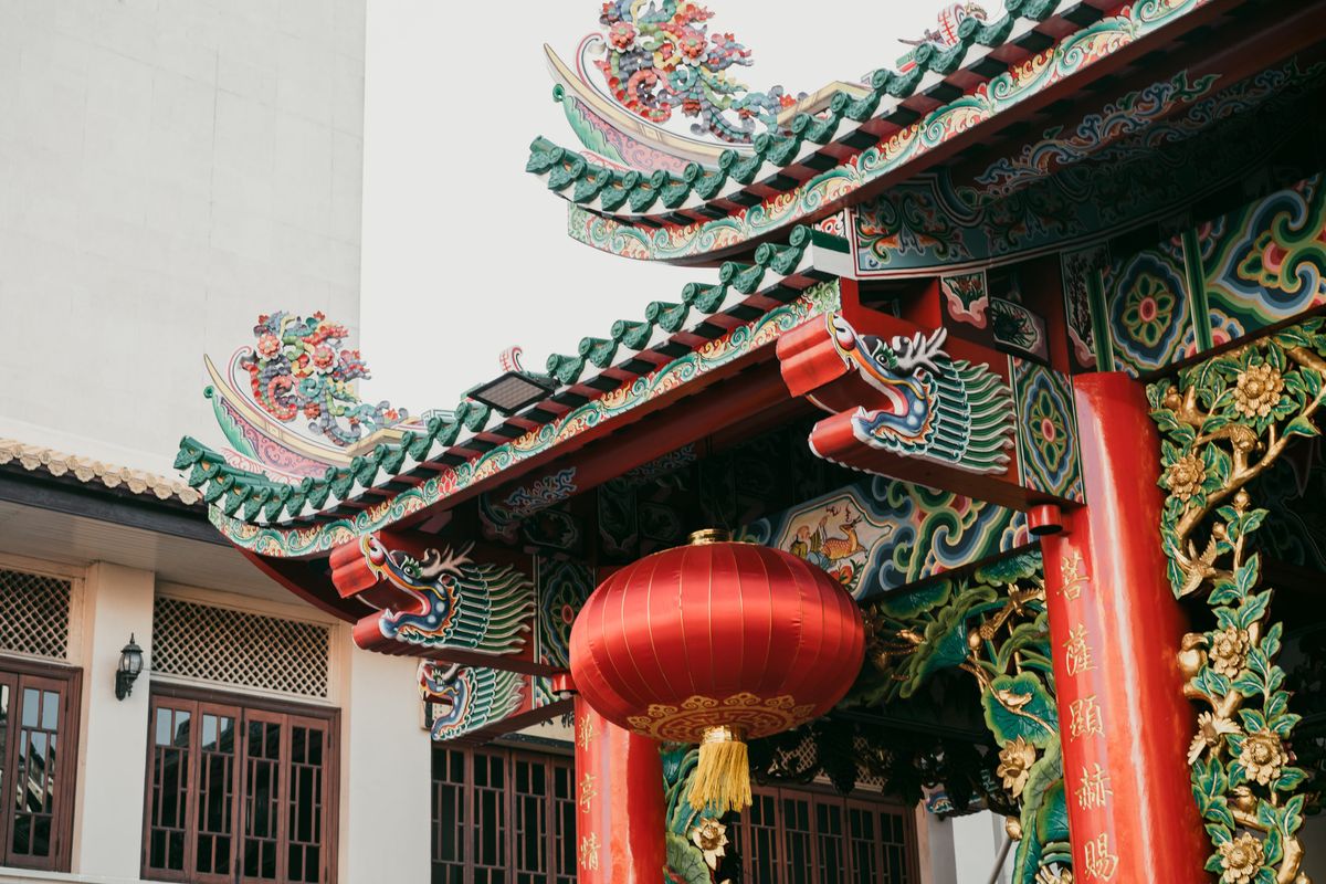 Red Chinese lantern hanging outside a temple — a symbol of Cantonese luck and superstition