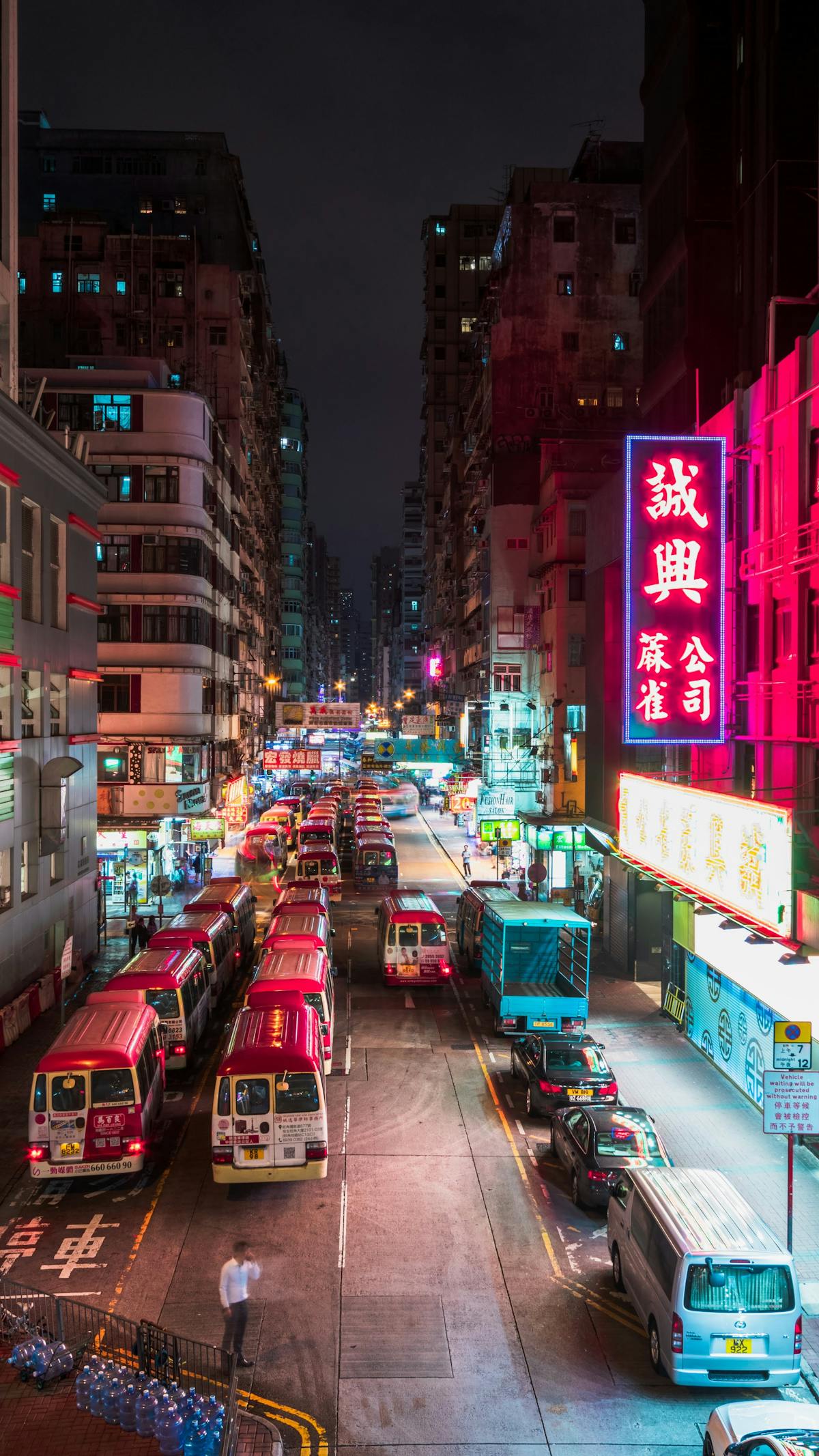 Hong Kong streets lit up at night with glowing neon signs