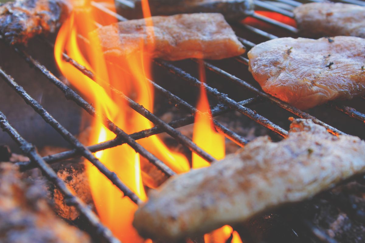 Grilled meat with crispy skin cooked over open flames