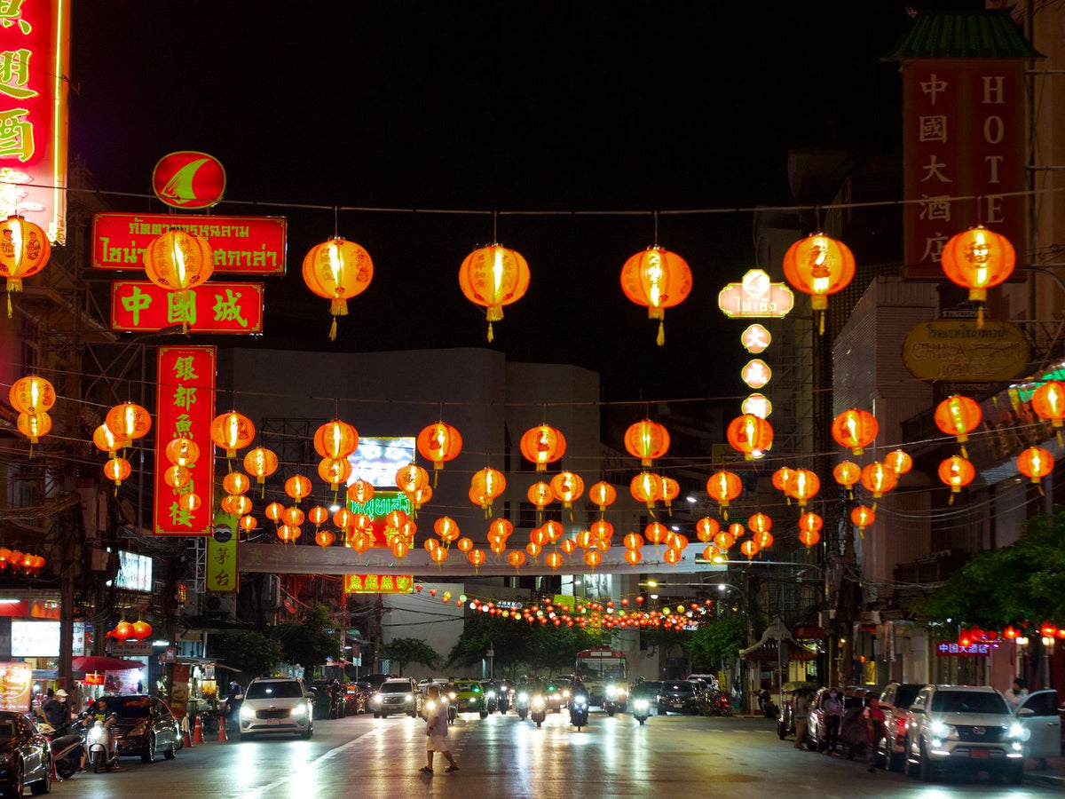 Traditional Chinese red lanterns strung over a Hong Kong street at night