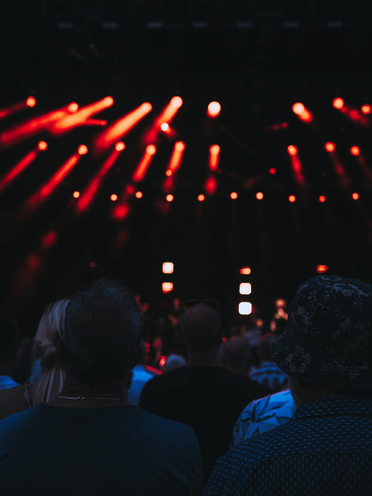Dramatic concert stage with professional lighting and spotlights illuminating a performance area