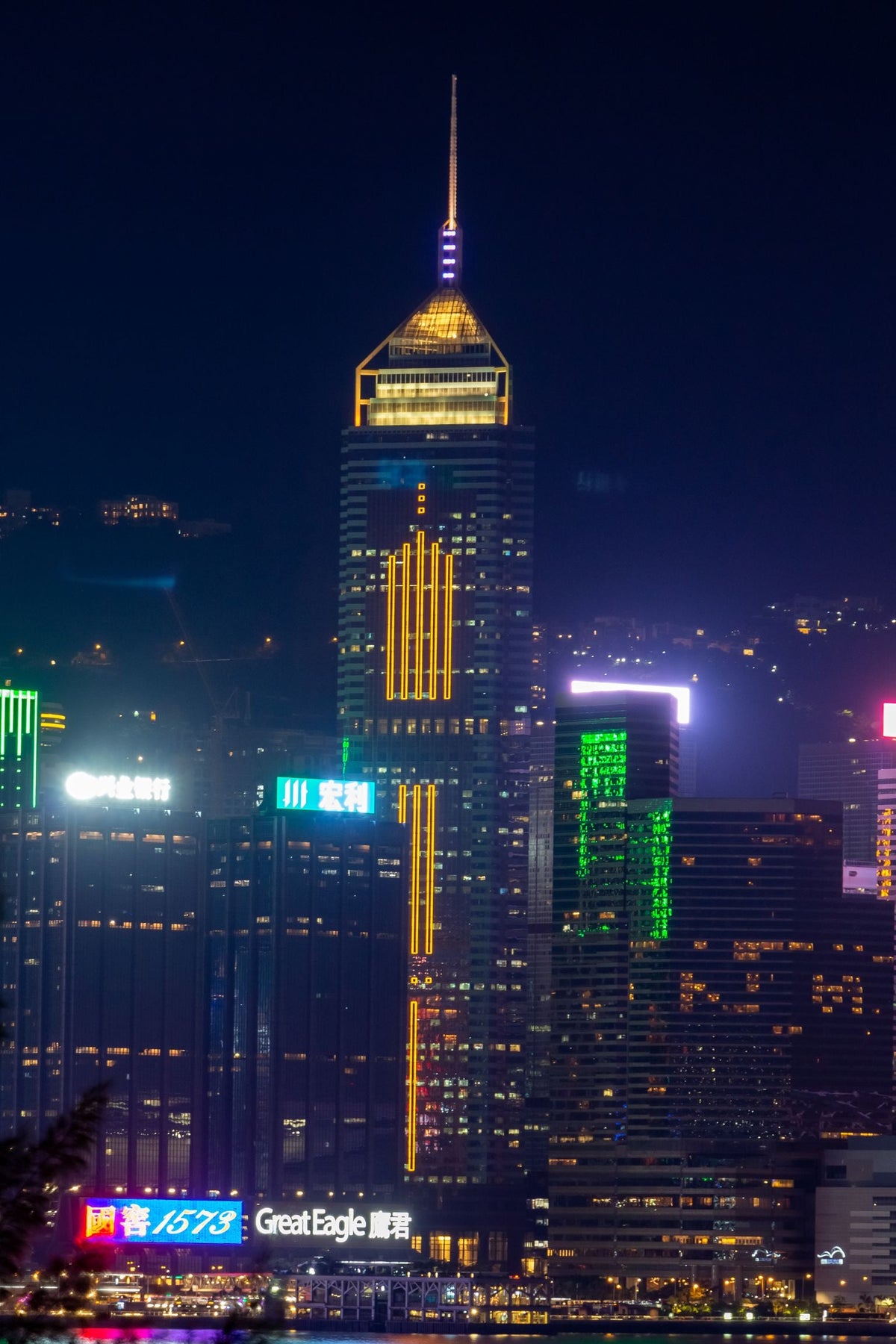 Hong Kong Central skyline at night with illuminated office towers — the natural habitat of the 打工仔