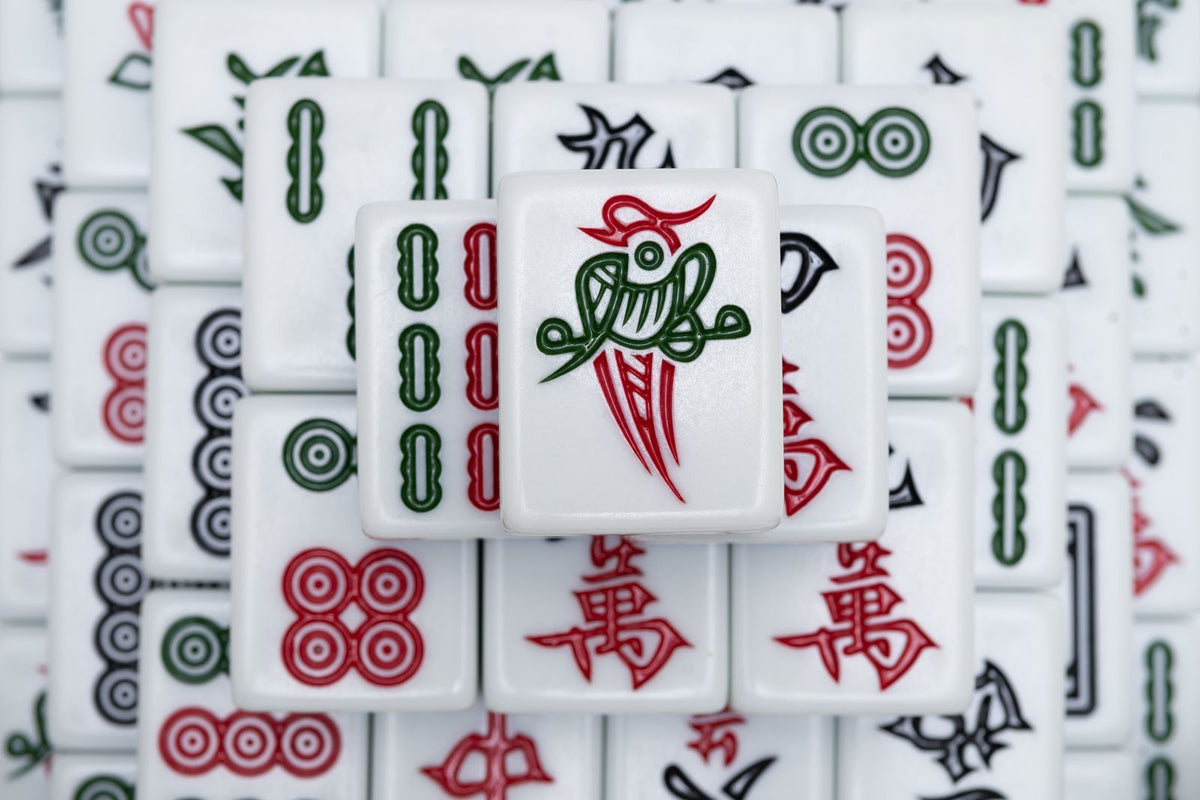 Close-up of Chinese mahjong tiles arranged on a table for a game