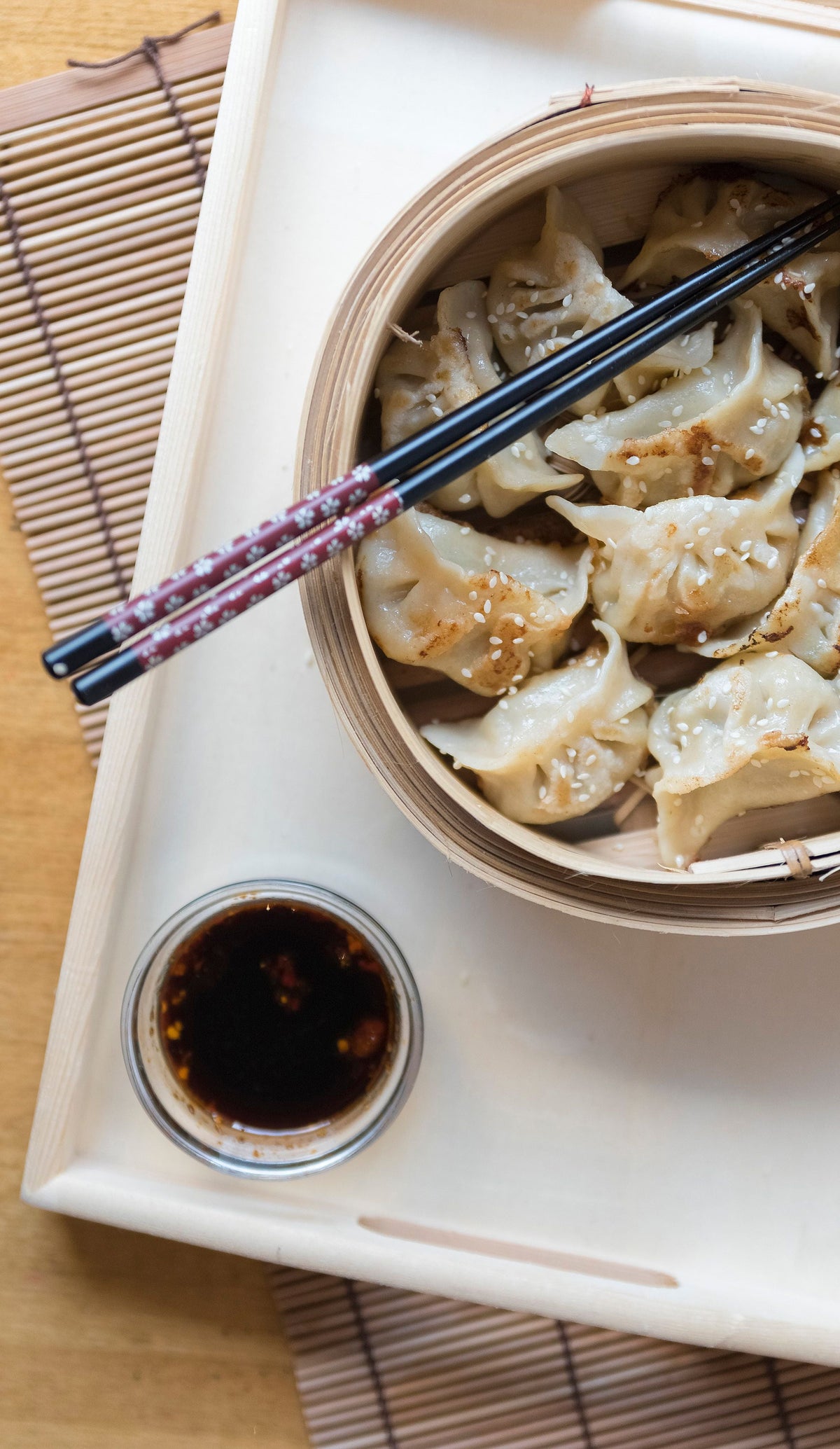 Steamed shrimp dumplings served in a bamboo steamer basket from above