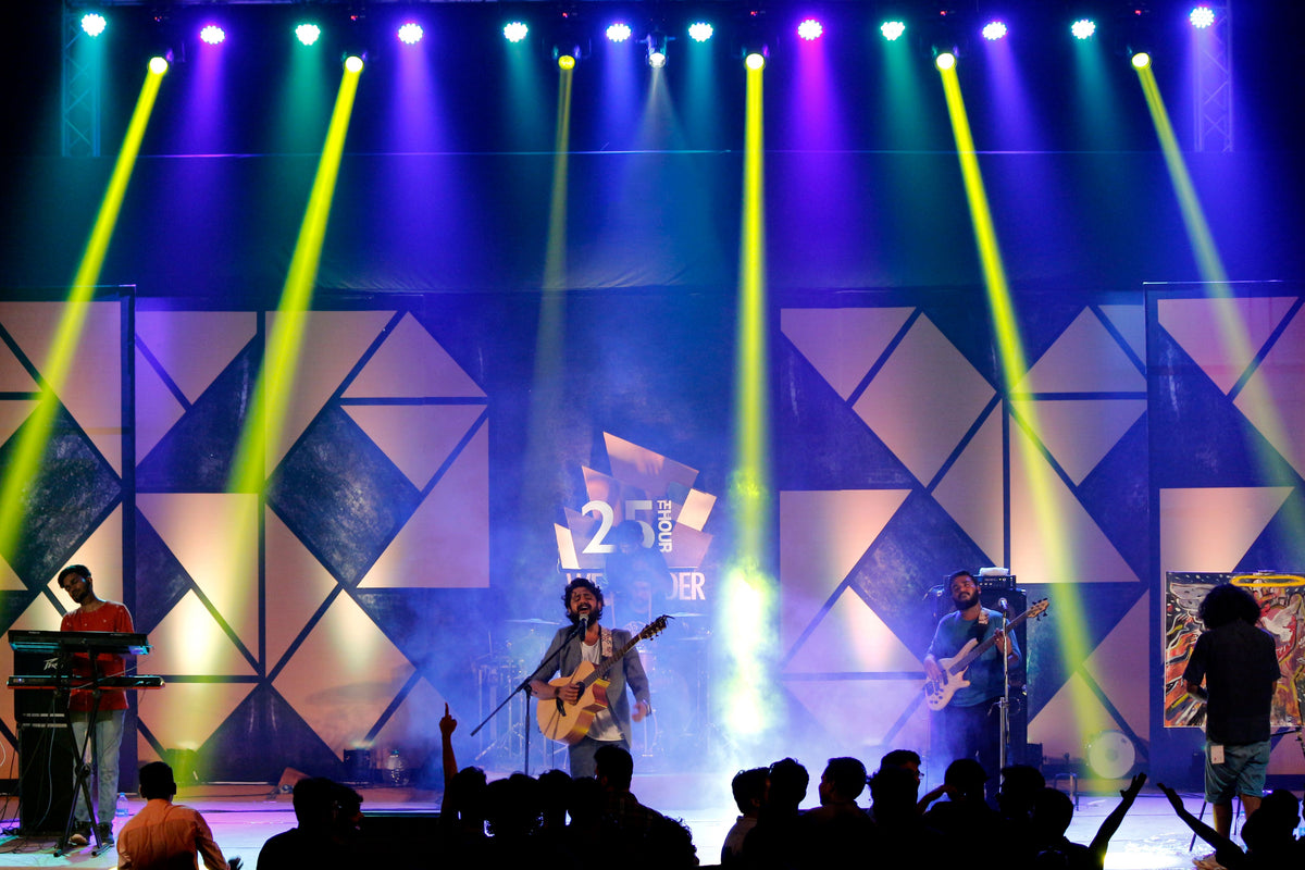 Energetic live Cantopop concert performance on stage with dynamic lighting at night