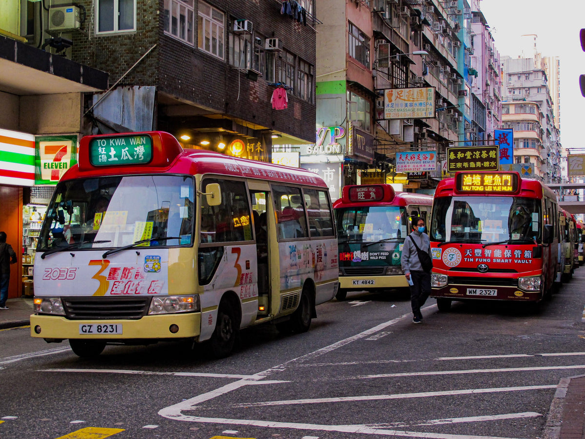 Bustling Hong Kong street with colorful mini buses and city life