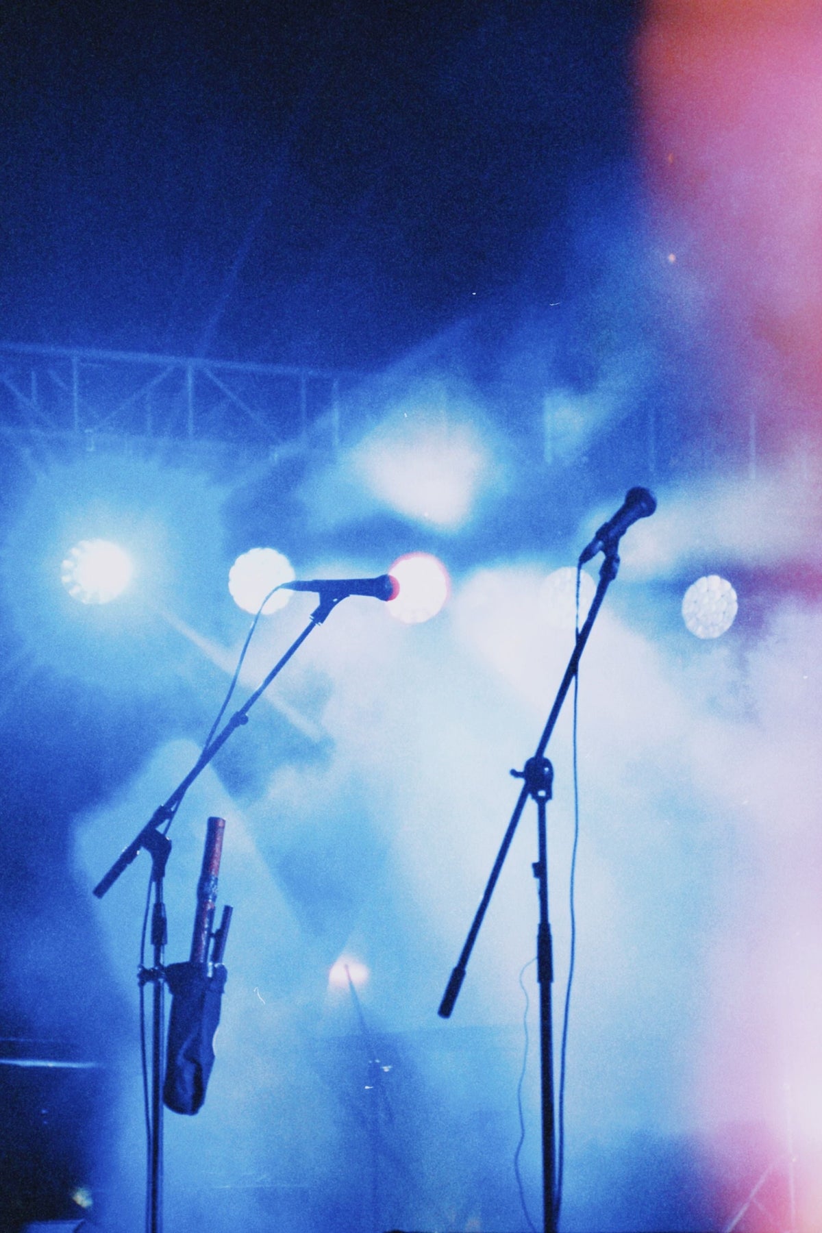 Energetic concert stage with colorful lights and microphones