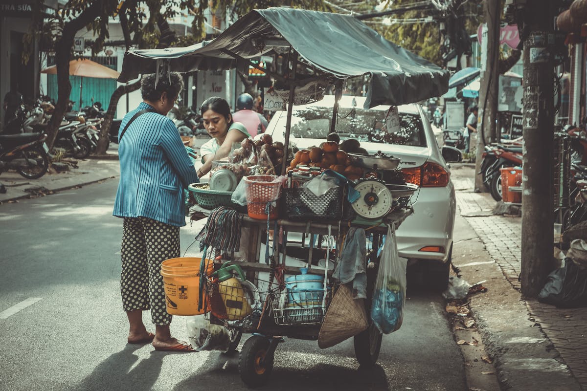 Bustling Asian street market with vendors selling traditional food items
