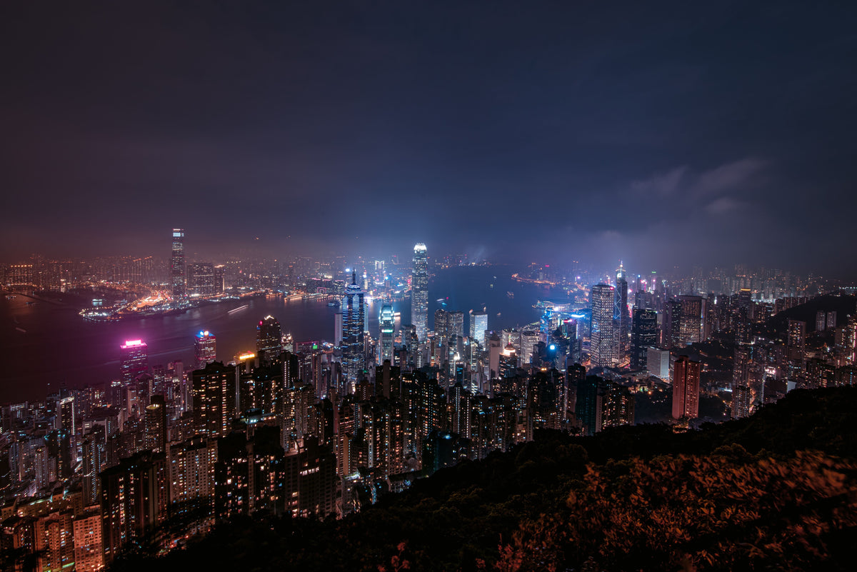 Nighttime elevated view of Hong Kong brightly lit skyscrapers and city streets