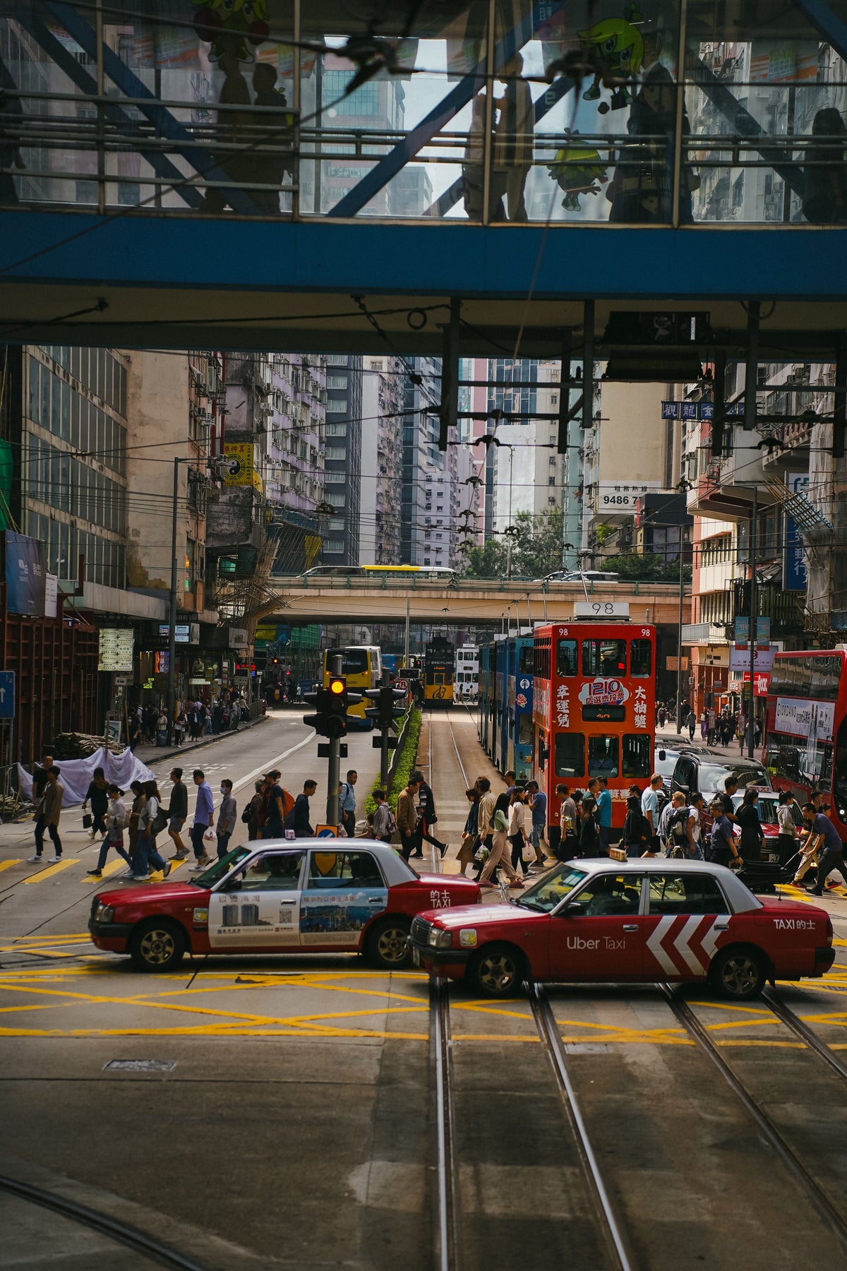 A busy Hong Kong street with trams and pedestrians