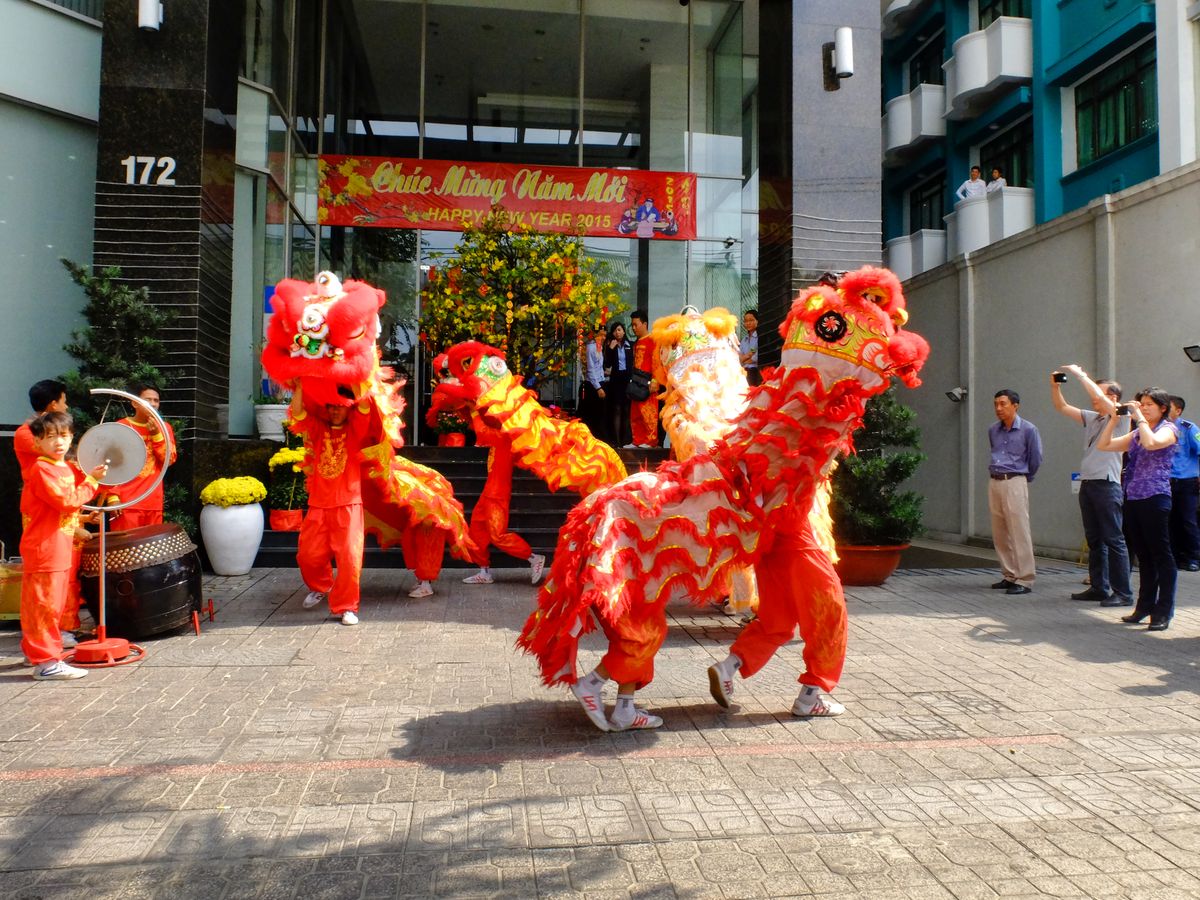 Performers in colourful costumes carrying out a Chinese dragon dance in the street
