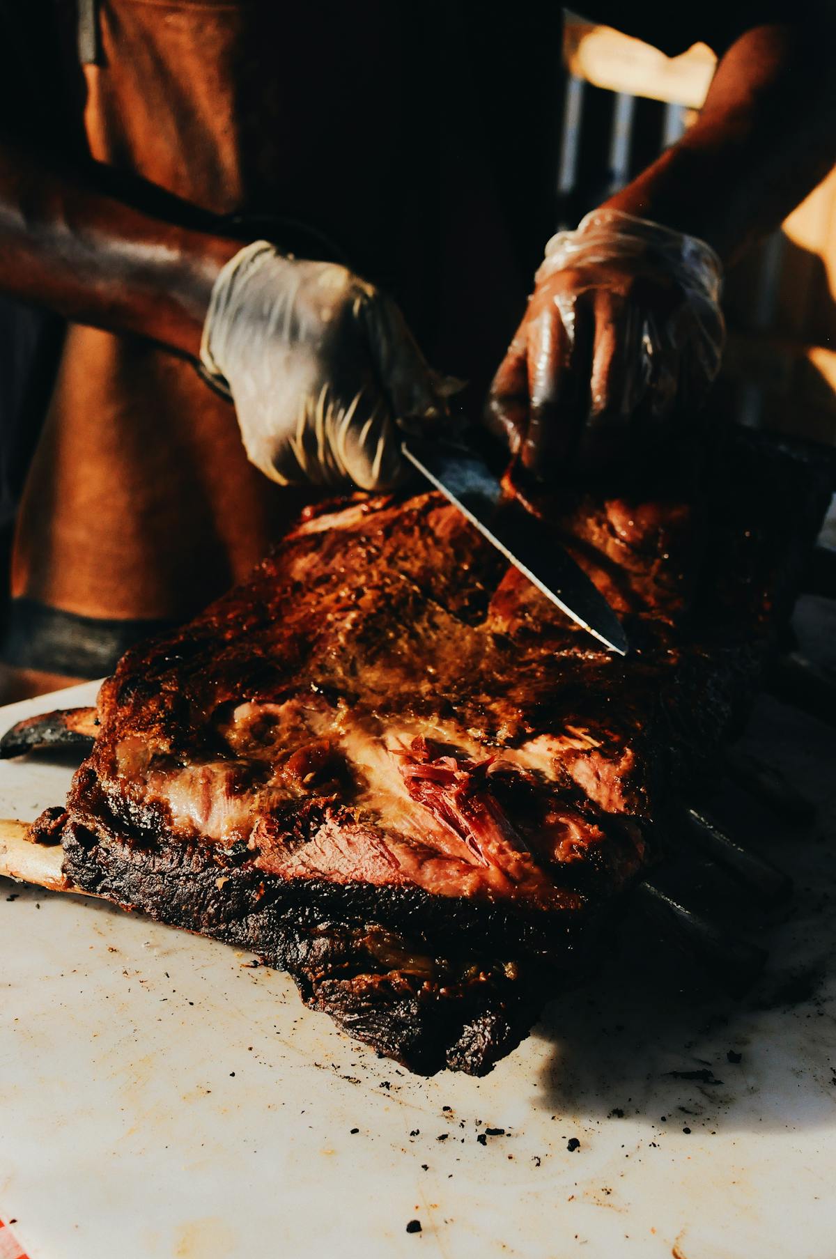 Chef cutting perfectly roasted goose meat with crispy skin and juicy tender interior
