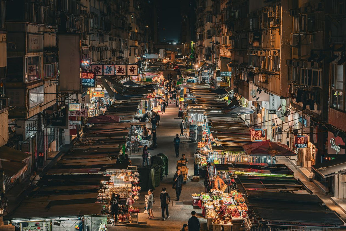 Drone shot of illuminated Mong Kok shopping area in Hong Kong at night