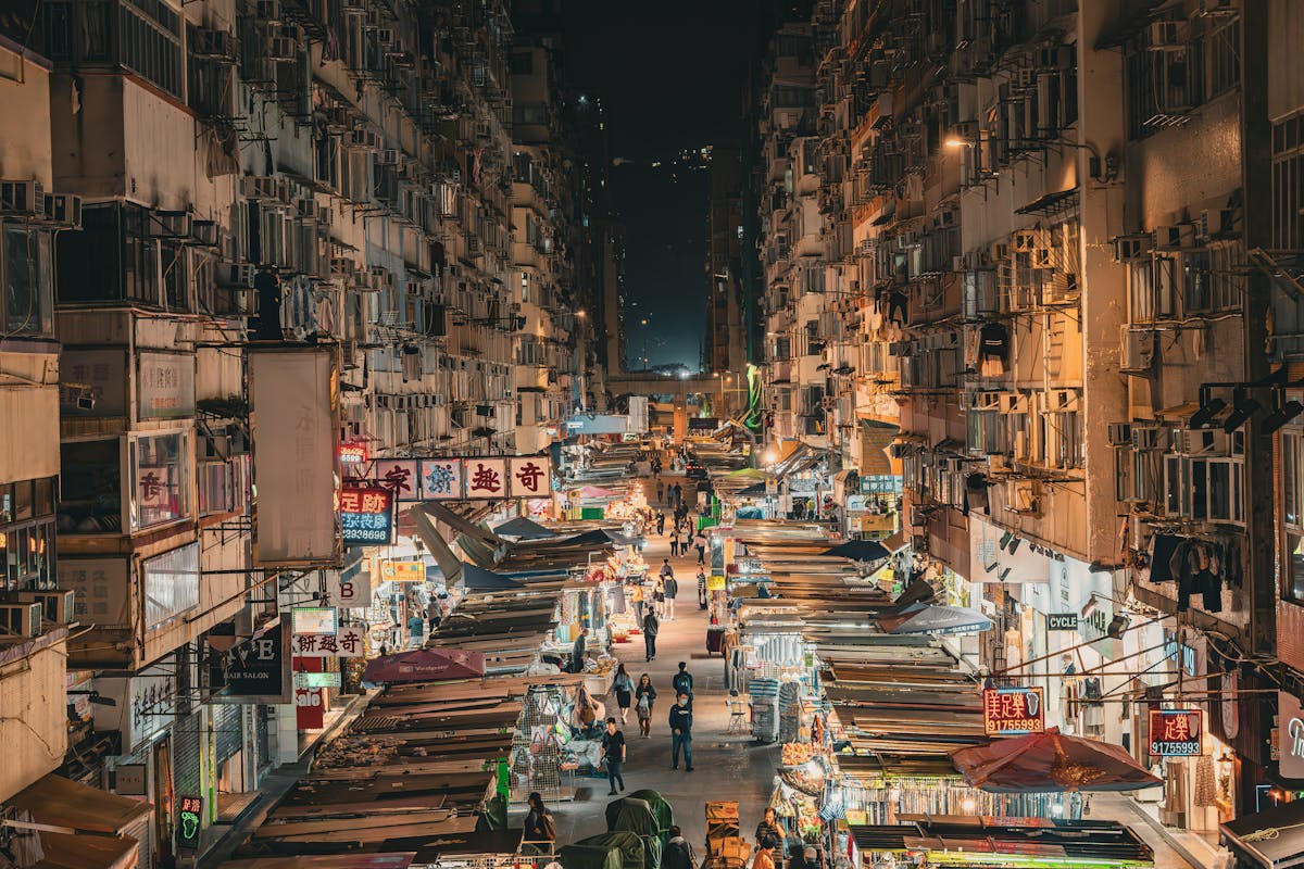 Drone shot of the illuminated Mong Kok shopping area in Hong Kong at night