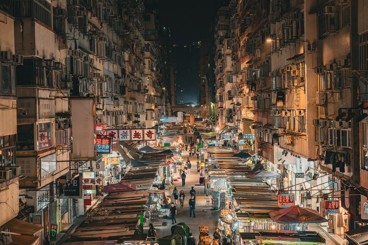 Aerial drone view of Mong Kok Hong Kong at night with illuminated street market