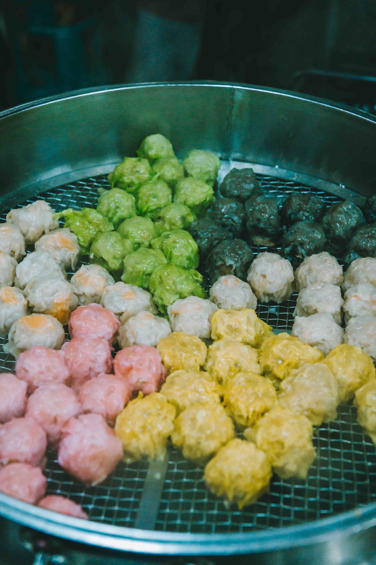 Dim sum stall with bamboo steamers at a Hong Kong-style street market