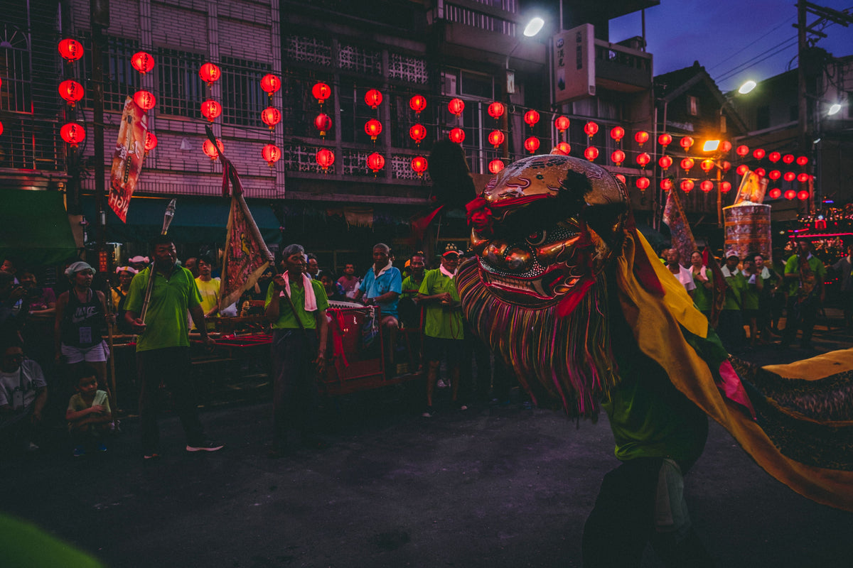 Colorful night festival featuring a dragon dance with lanterns on a bustling street