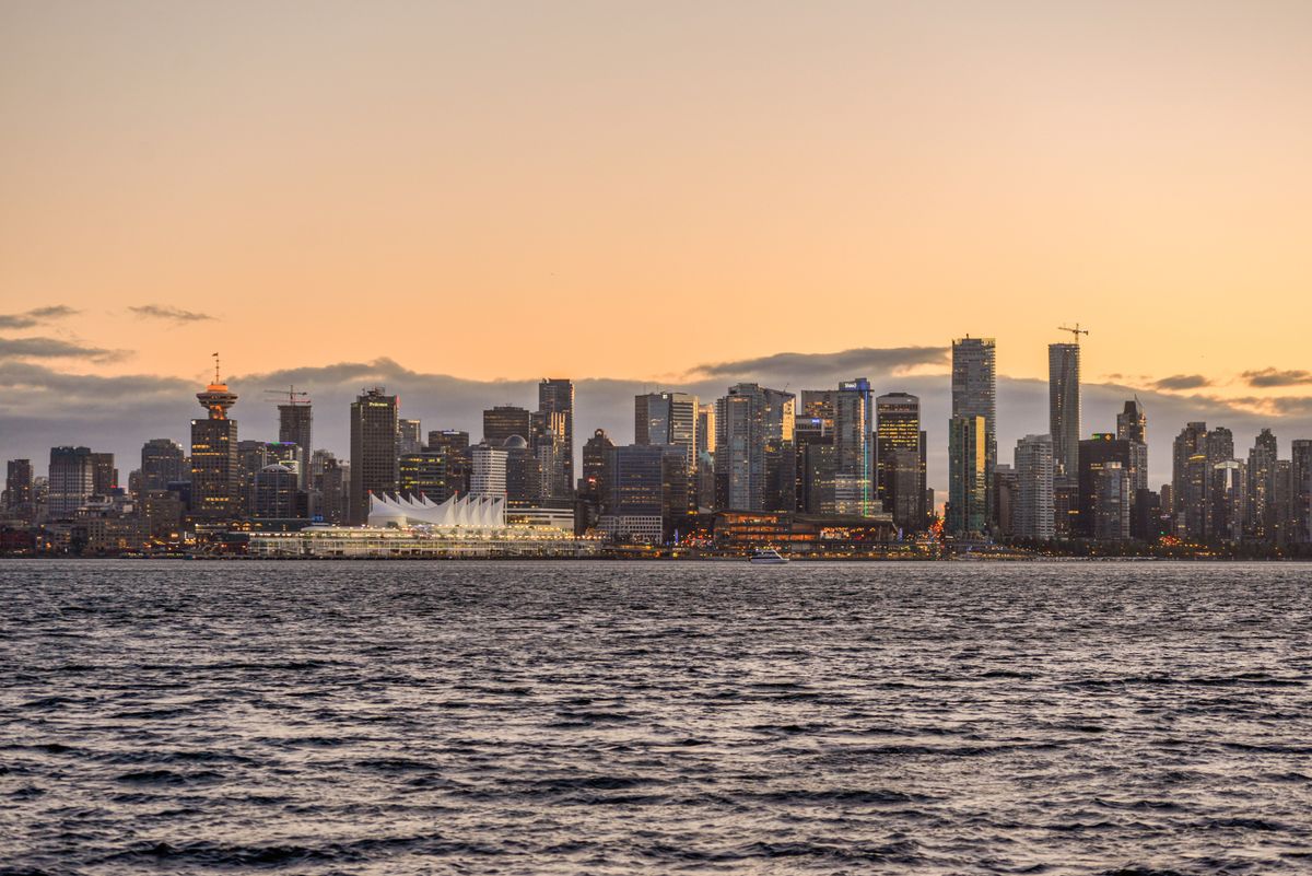 Vancouver downtown skyline at sunset with waterfront and mountains