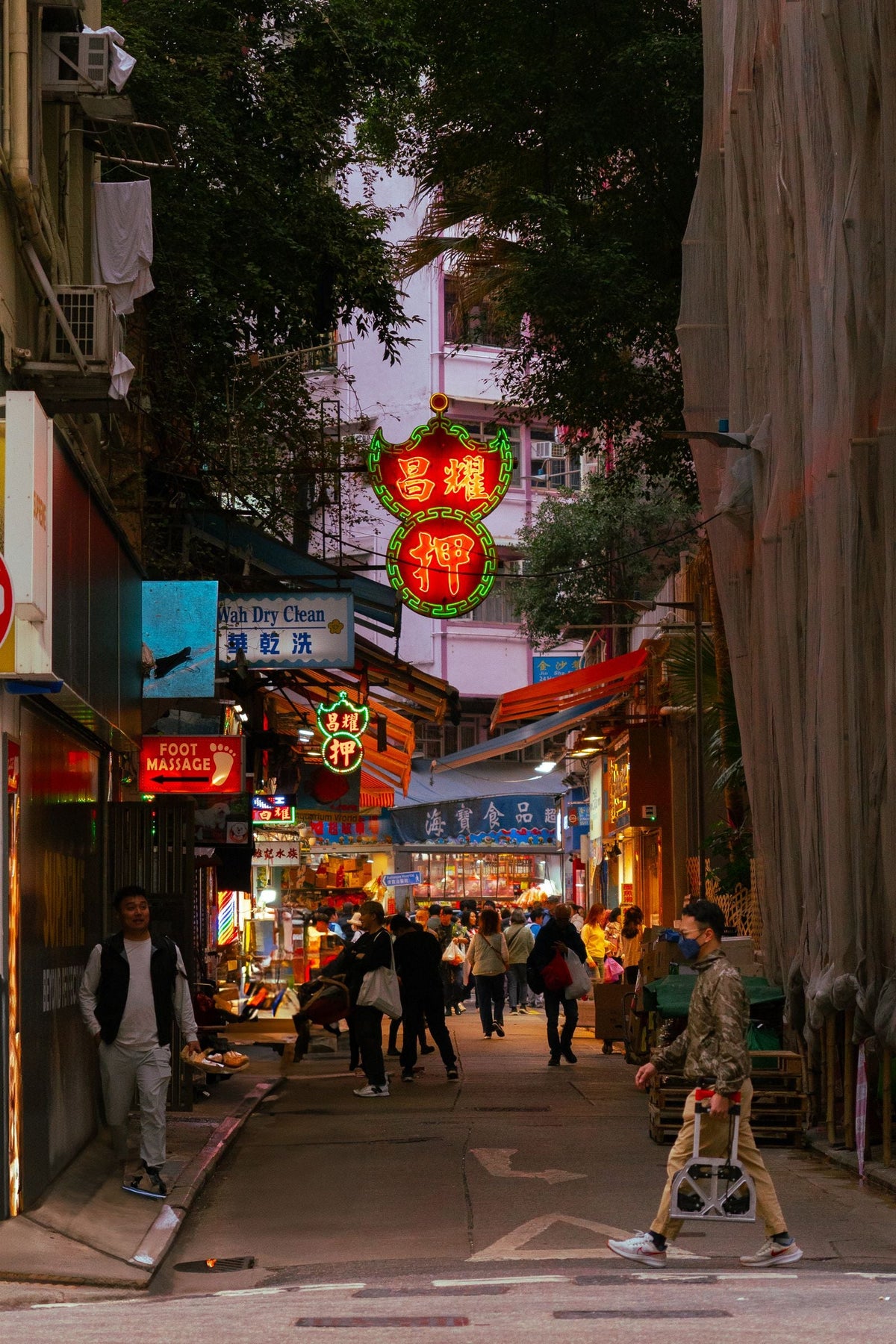Hong Kong alleyway at night with neon signs — the era that made Louis Koo