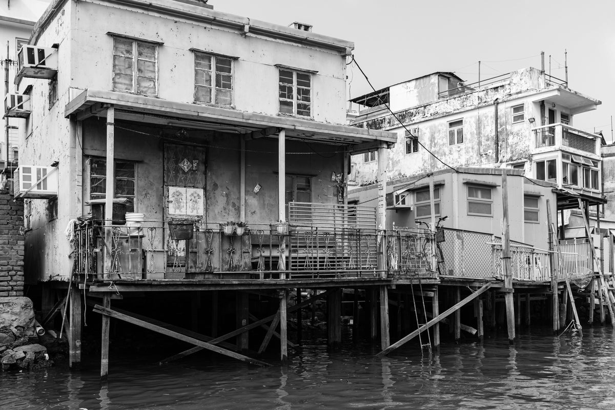Traditional wooden stilt houses of Tai O fishing village in Hong Kong sitting above tidal waters