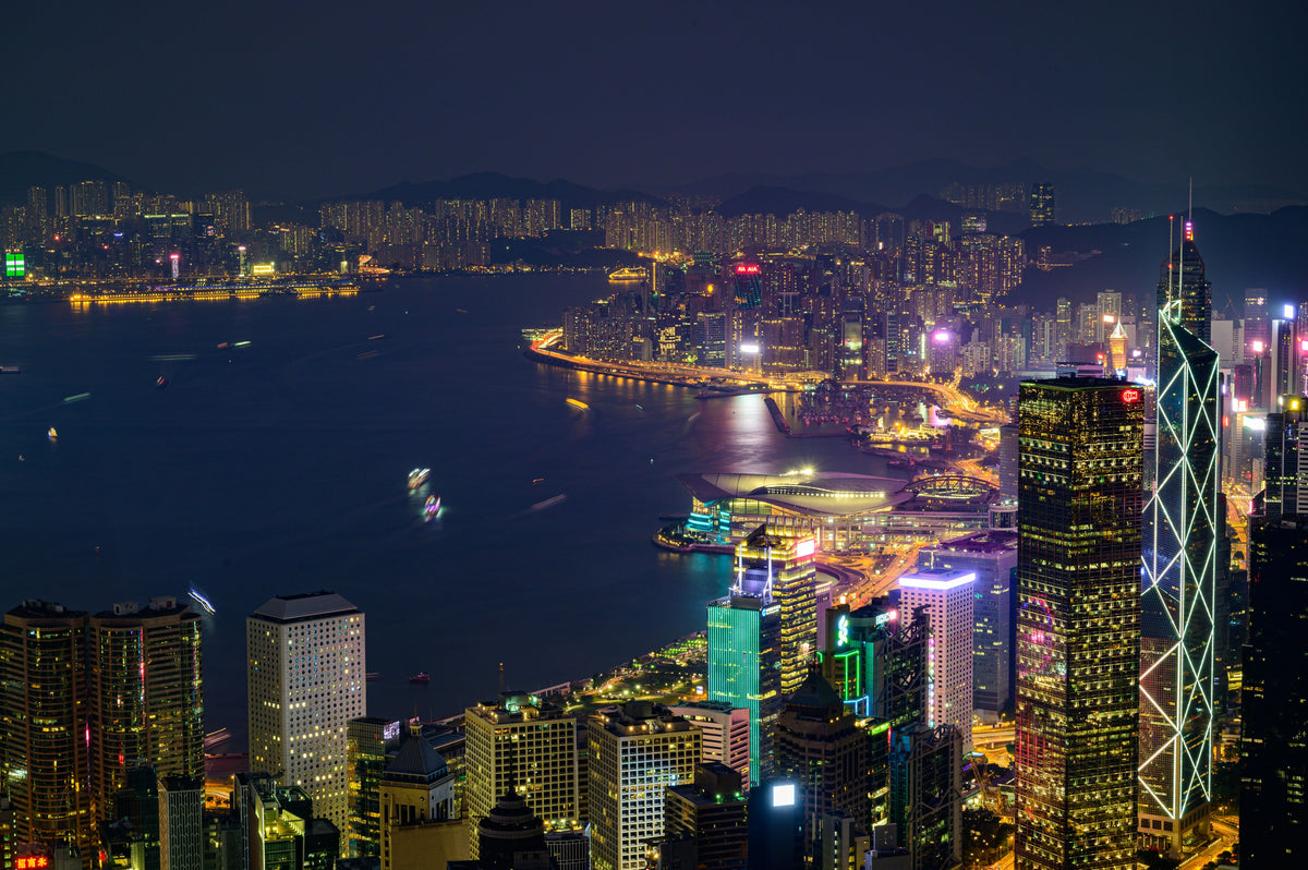 Hong Kong Island skyline at night across Victoria Harbour — the exact stage the full Mid-Autumn moon lights up