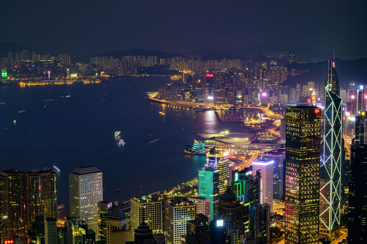 Hong Kong skyline at night with illuminated skyscrapers across Victoria Harbour