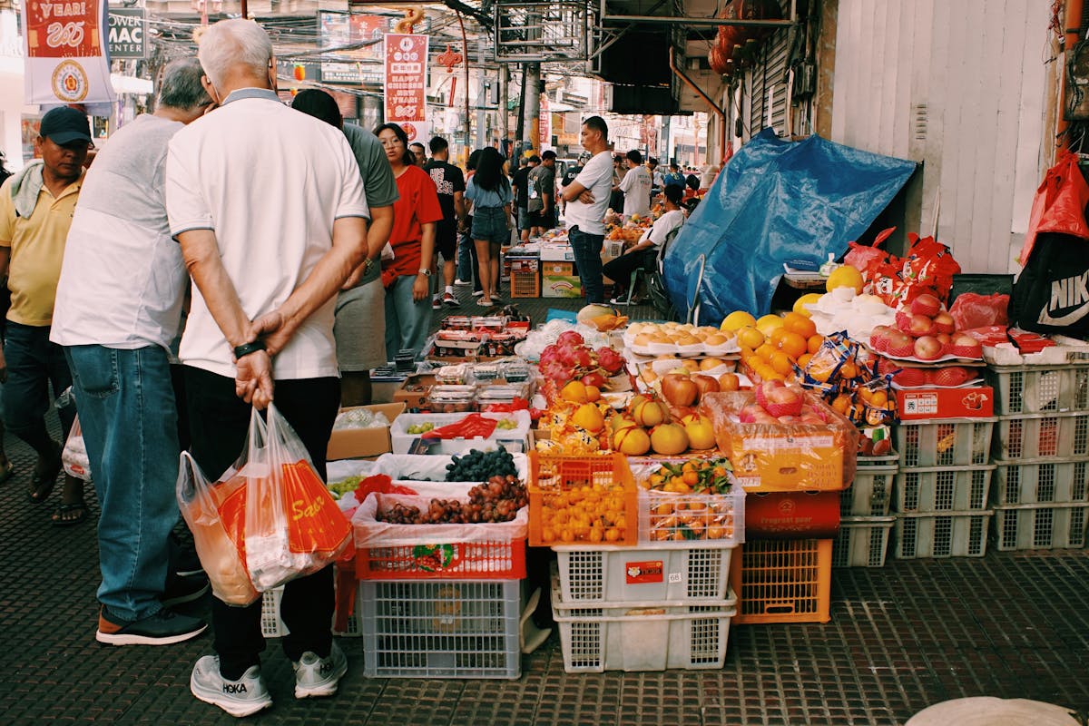 Vibrant Asian street market with fresh fruits and bustling atmosphere