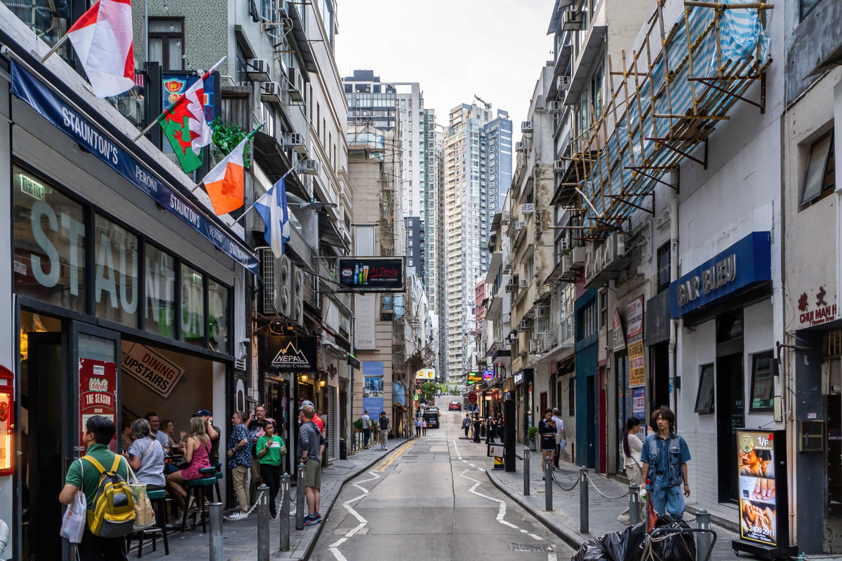 Vibrant street scene in Hong Kong Soho district at night with restaurants and people