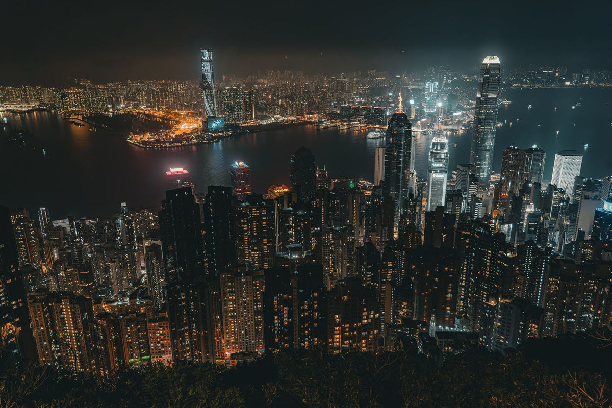 Aerial view of the Hong Kong night skyline — a city built on Cantonese food traditions like double-skin milk