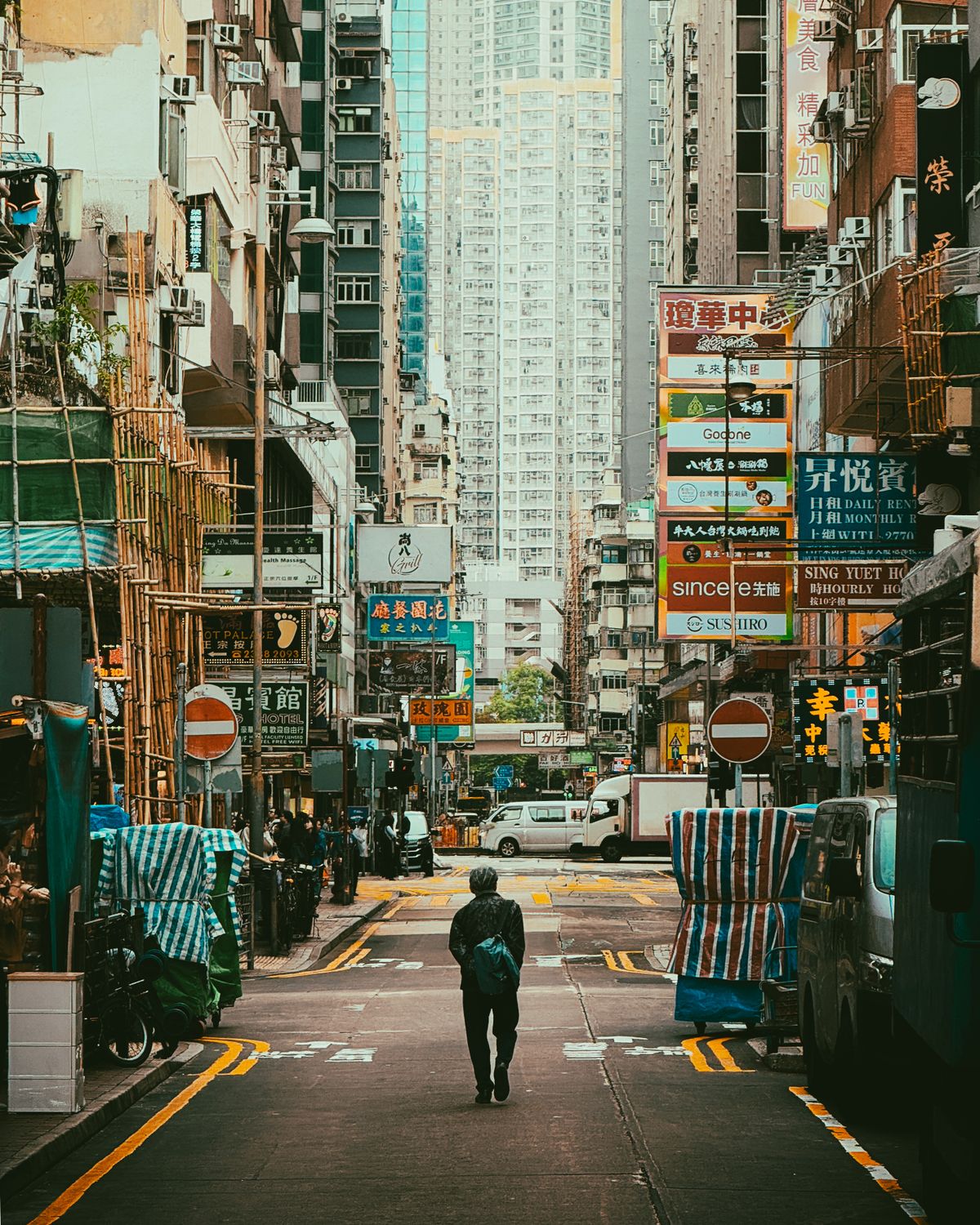 Neon-lit Hong Kong street bustling in the evening heat