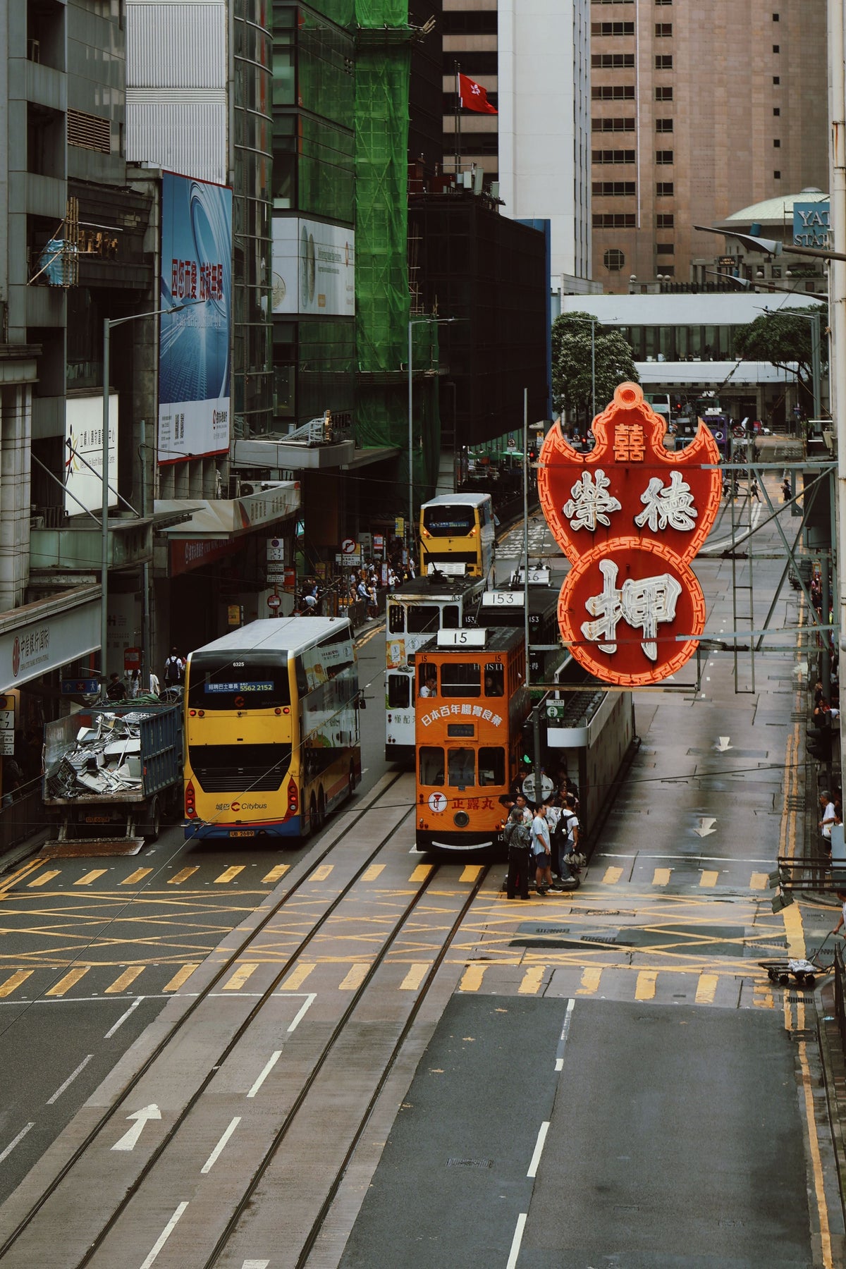 Iconic Hong Kong street scene with double-decker trams and old shopfront signage