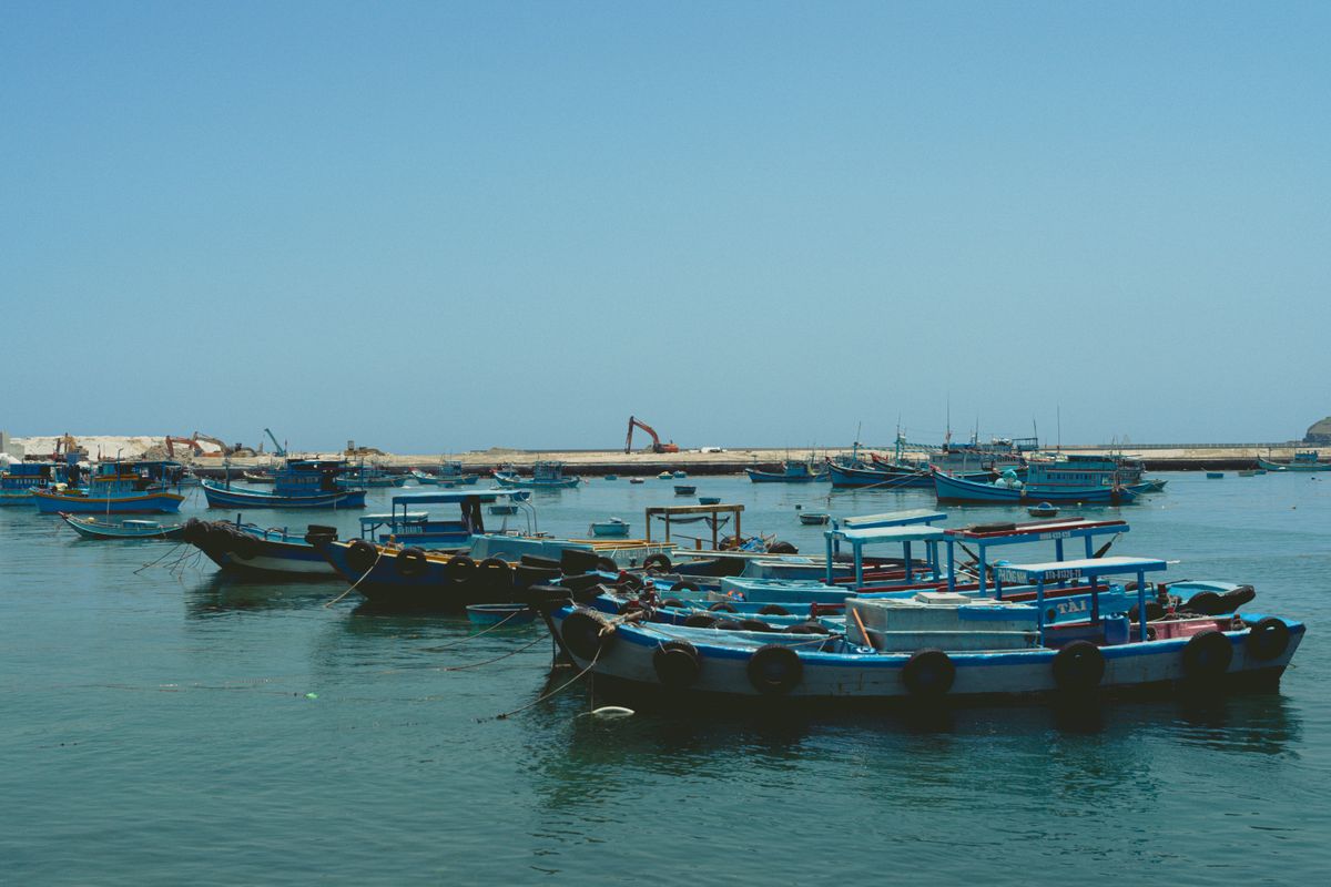 Traditional wooden fishing boats moored in calm coastal waters