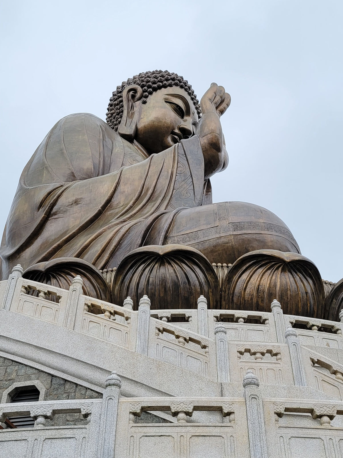 The large bronze Tian Tan Big Buddha statue seated on a lotus throne atop a Lantau mountain in Hong Kong