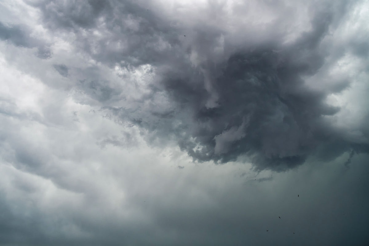 Swirling dramatic storm clouds in a dark sky before a tropical storm