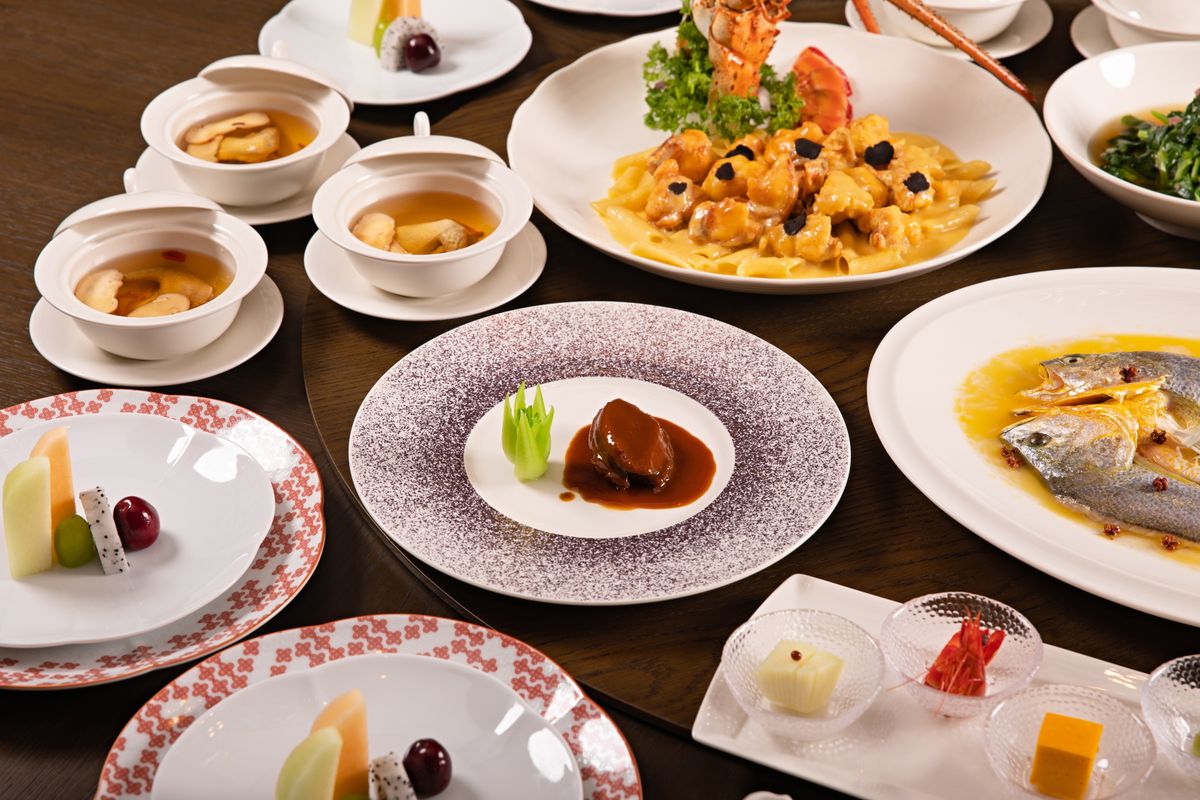 Elegant Chinese banquet spread with many dishes on a shared table
