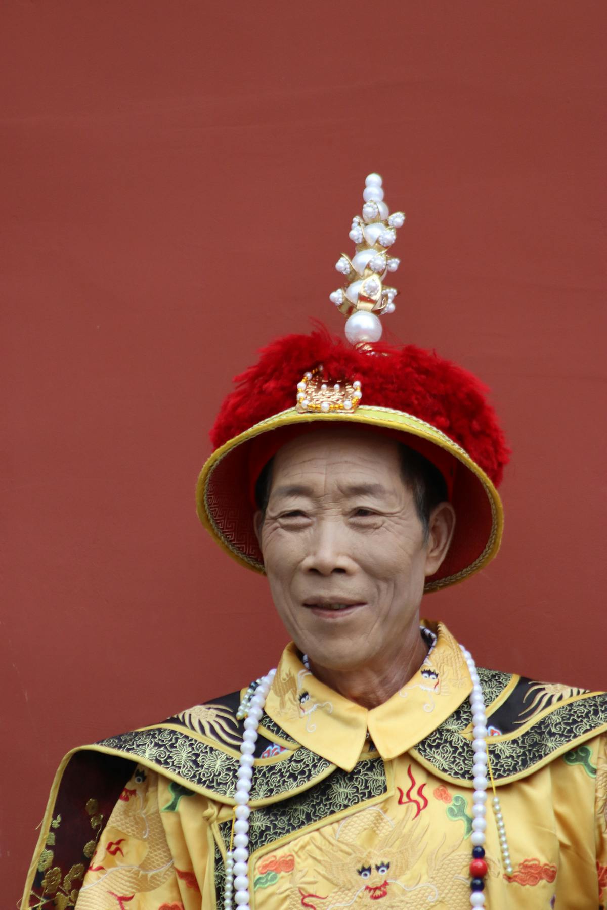 Portrait of a person in traditional Chinese attire and headwear