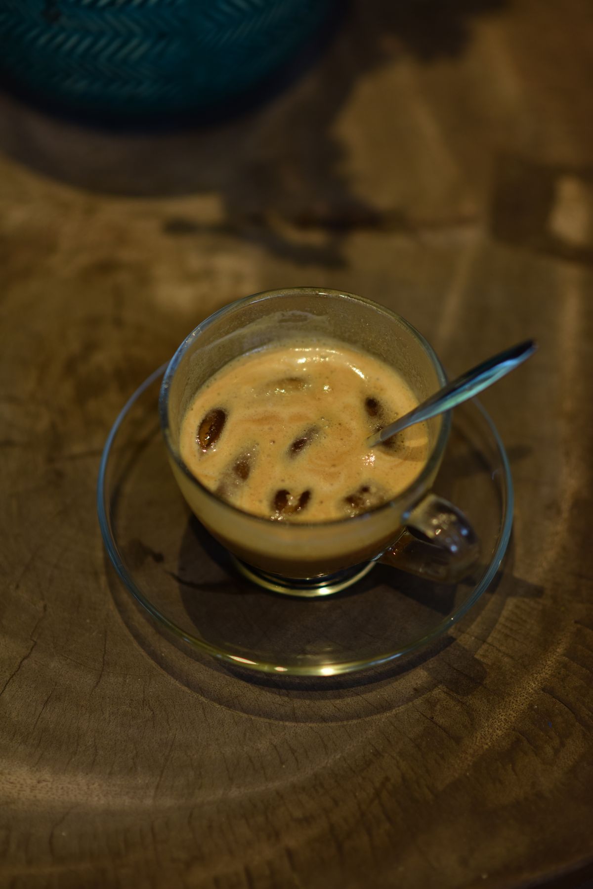 Iced coffee drink in a glass cup on a wooden table