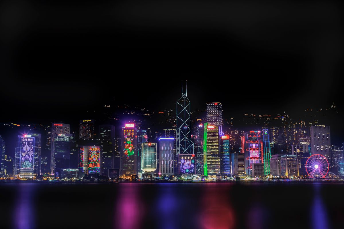 Vibrant Hong Kong skyline at night with illuminated skyscrapers reflected in the harbour