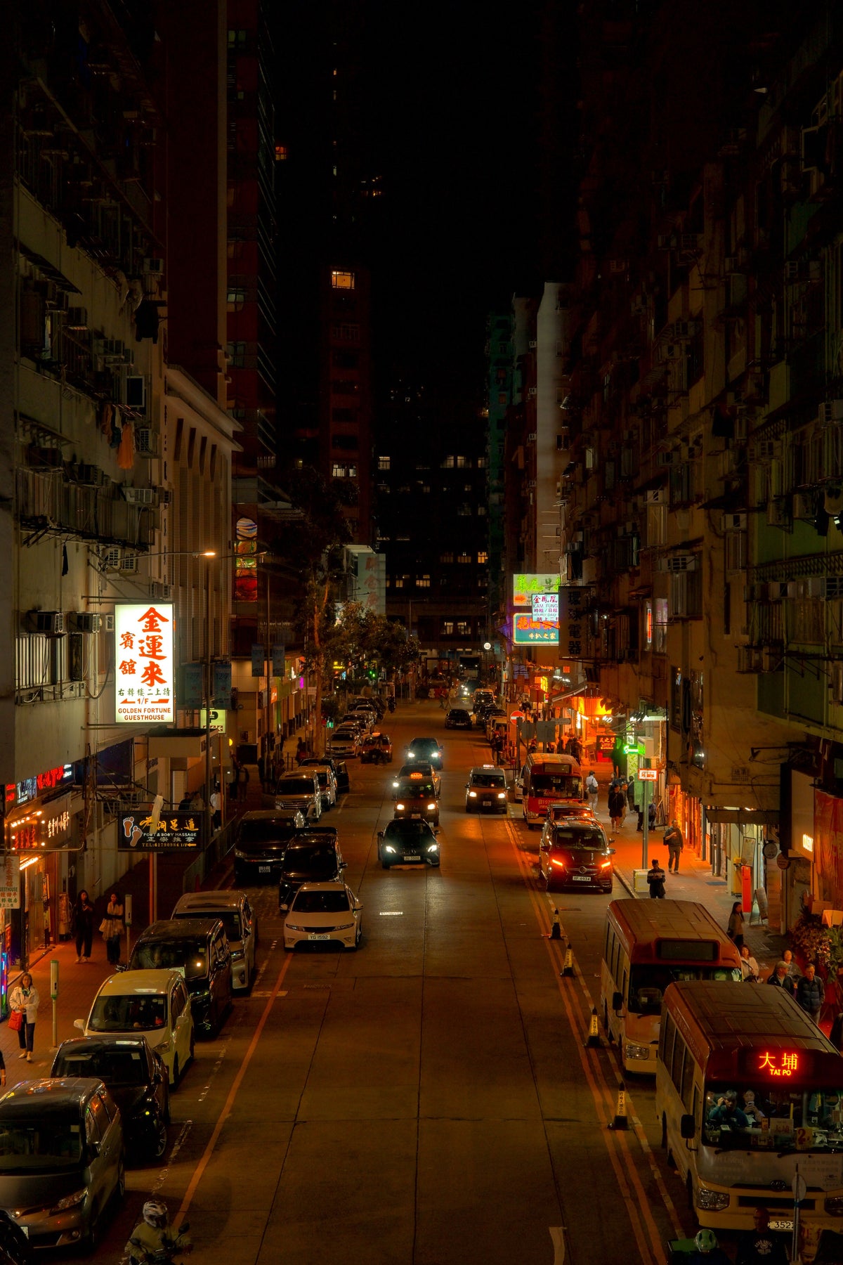 Bustling nighttime street scene in Kowloon Hong Kong