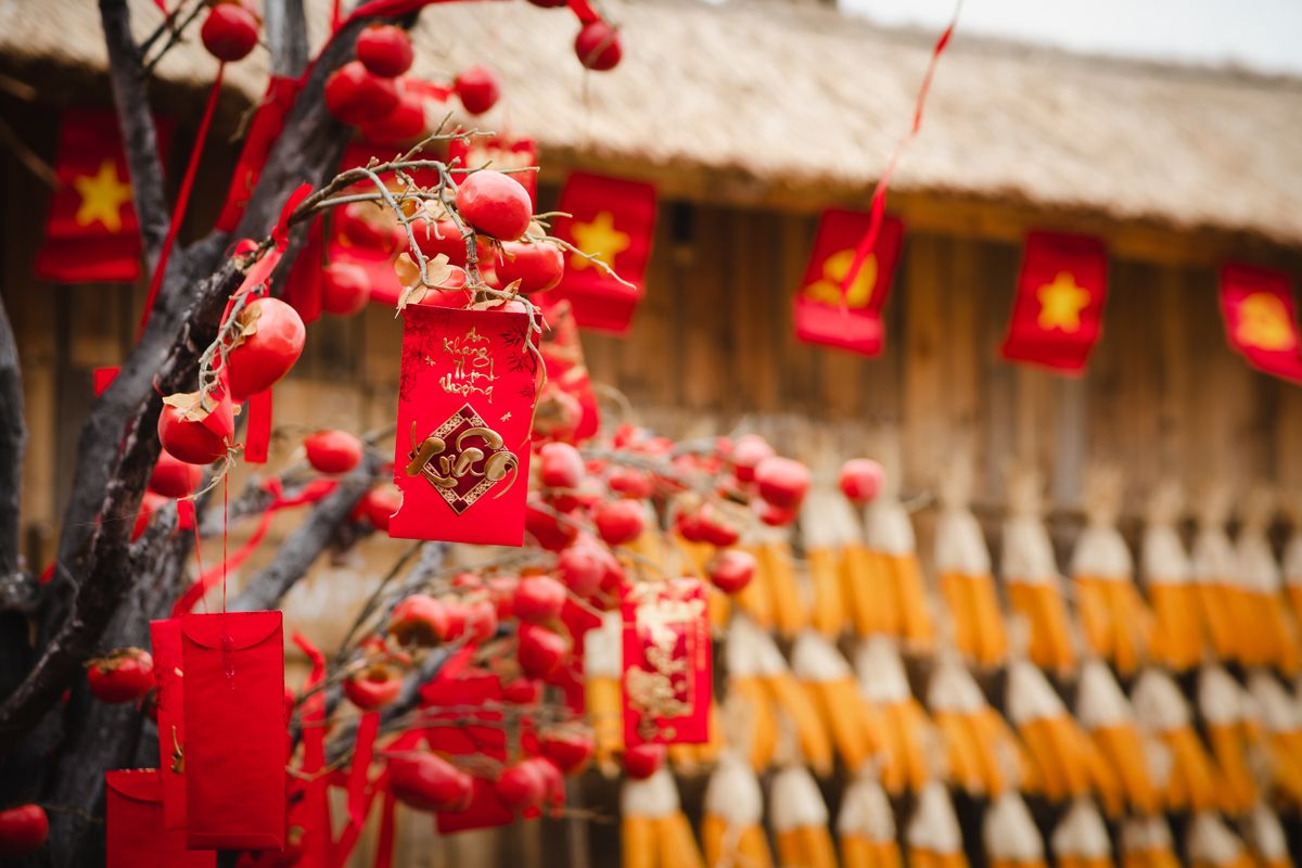 Red envelopes and Lunar New Year decorations laid out on a festive table